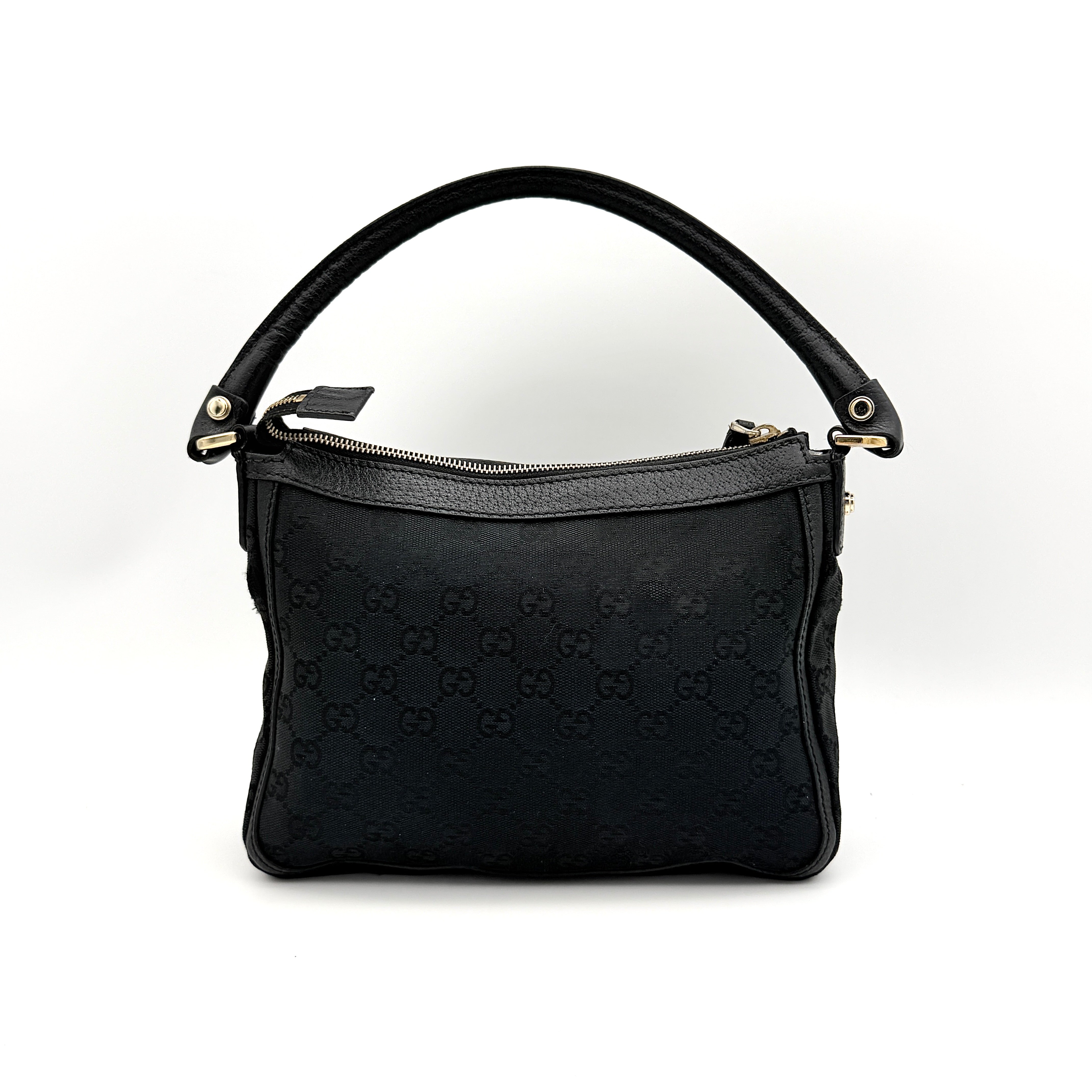 Front view of the Gucci GG Monogram Abbey Shoulder Bag in black with curved handle and gold hardware.