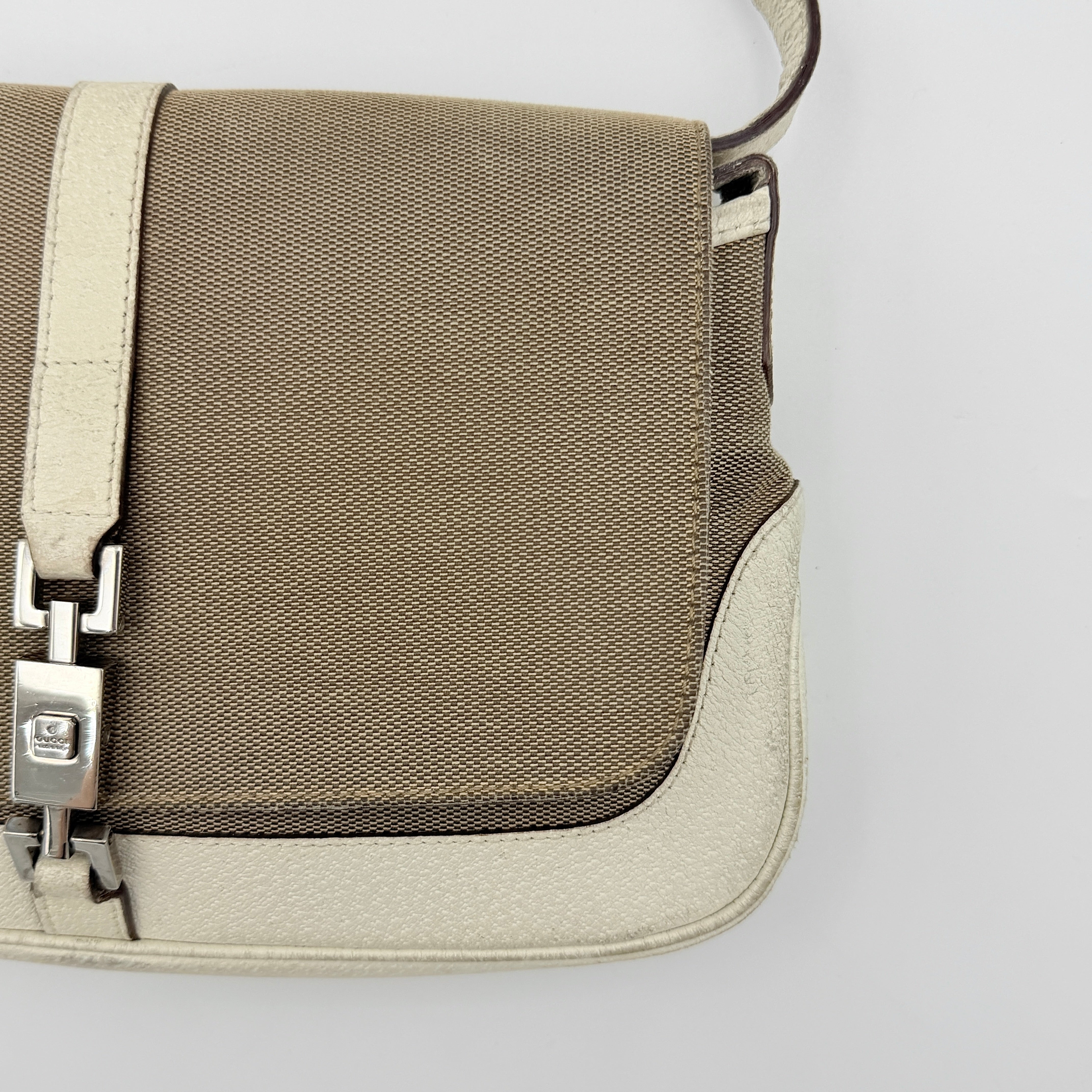 Gucci Jackie Shoulder Bag in brown canvas and white leather trim with silver-tone hardware, displayed against a clean background.