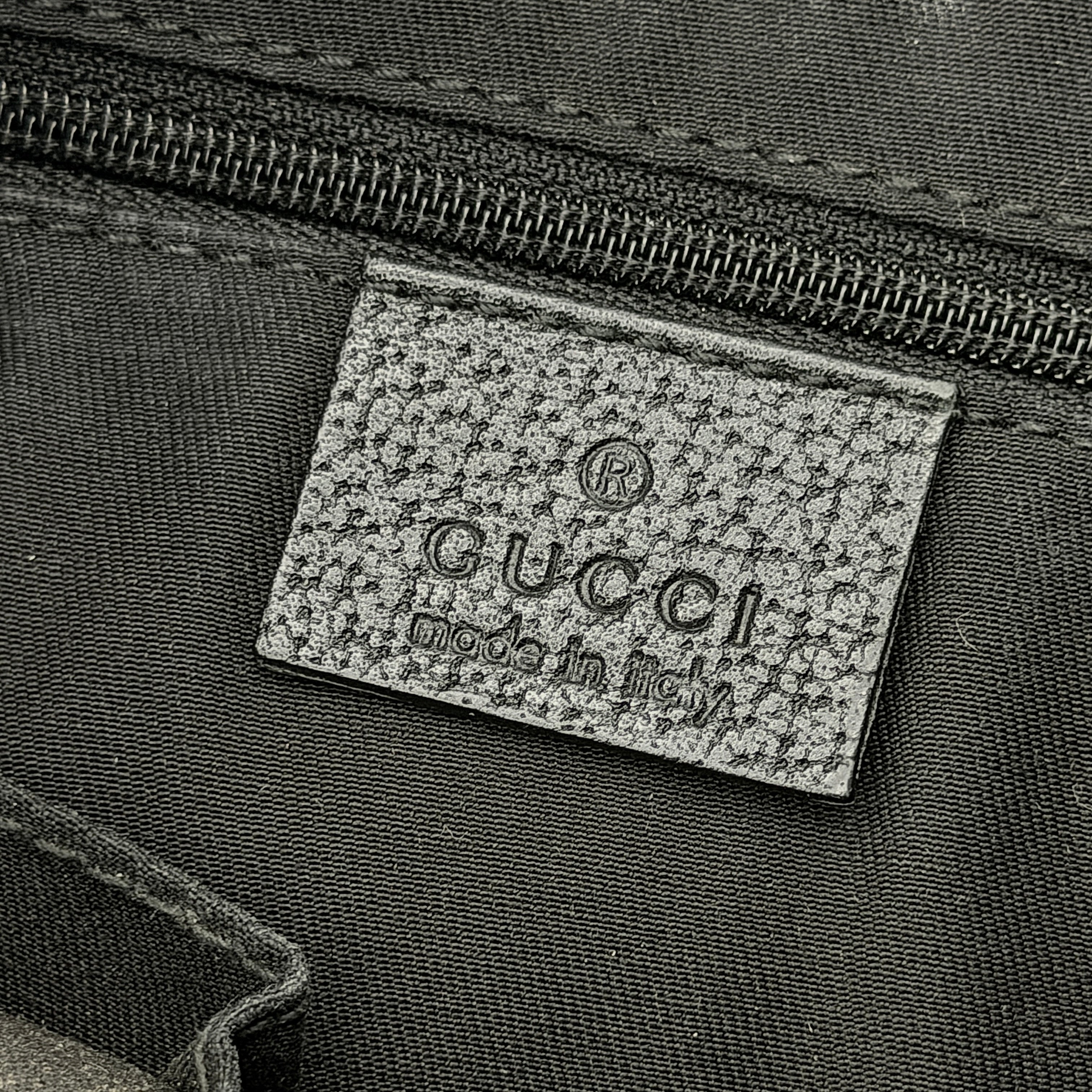 Front view of the Gucci GG Monogram Abbey Shoulder Bag in black with curved handle and gold hardware.