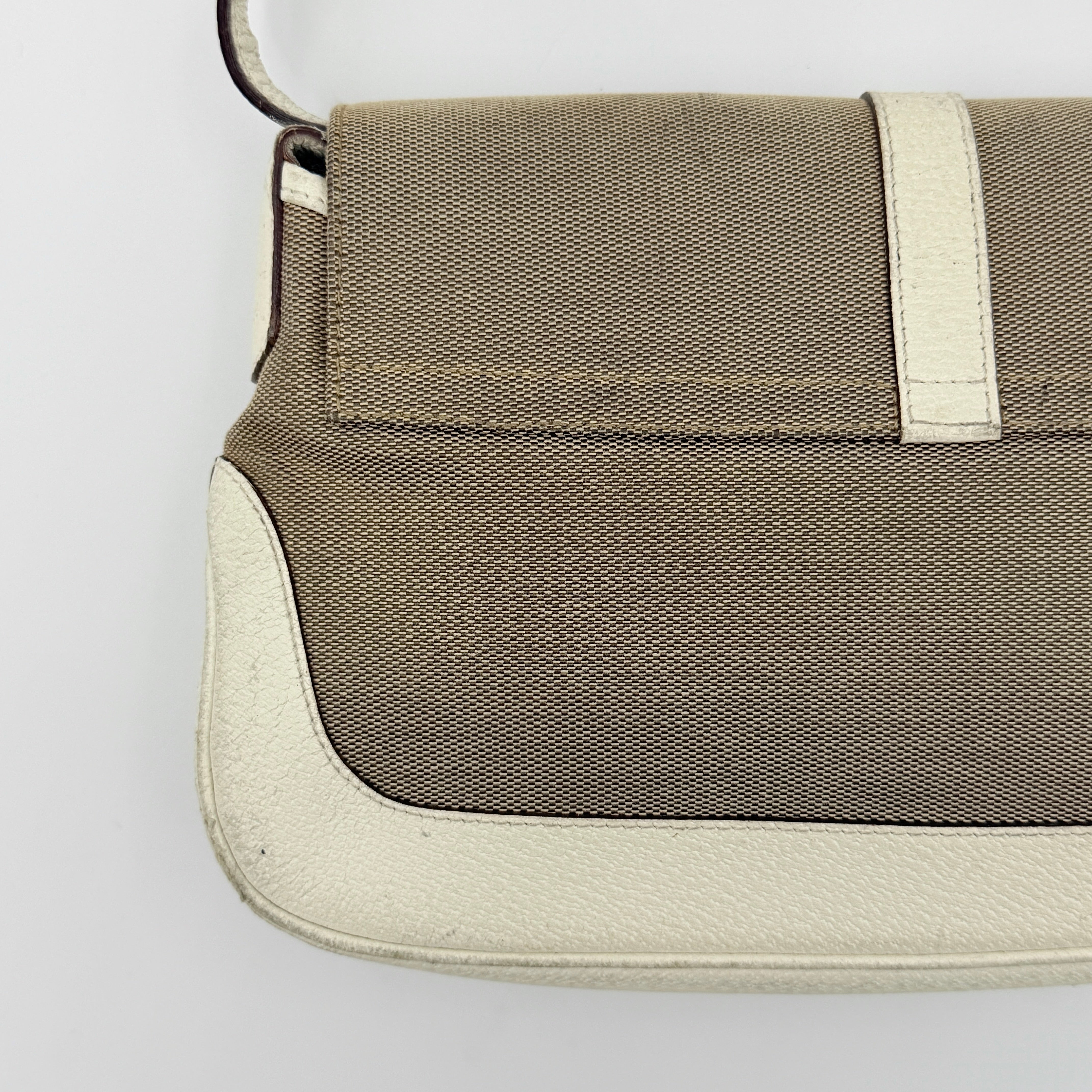 Gucci Jackie Shoulder Bag in brown canvas and white leather trim with silver-tone hardware, displayed against a clean background.