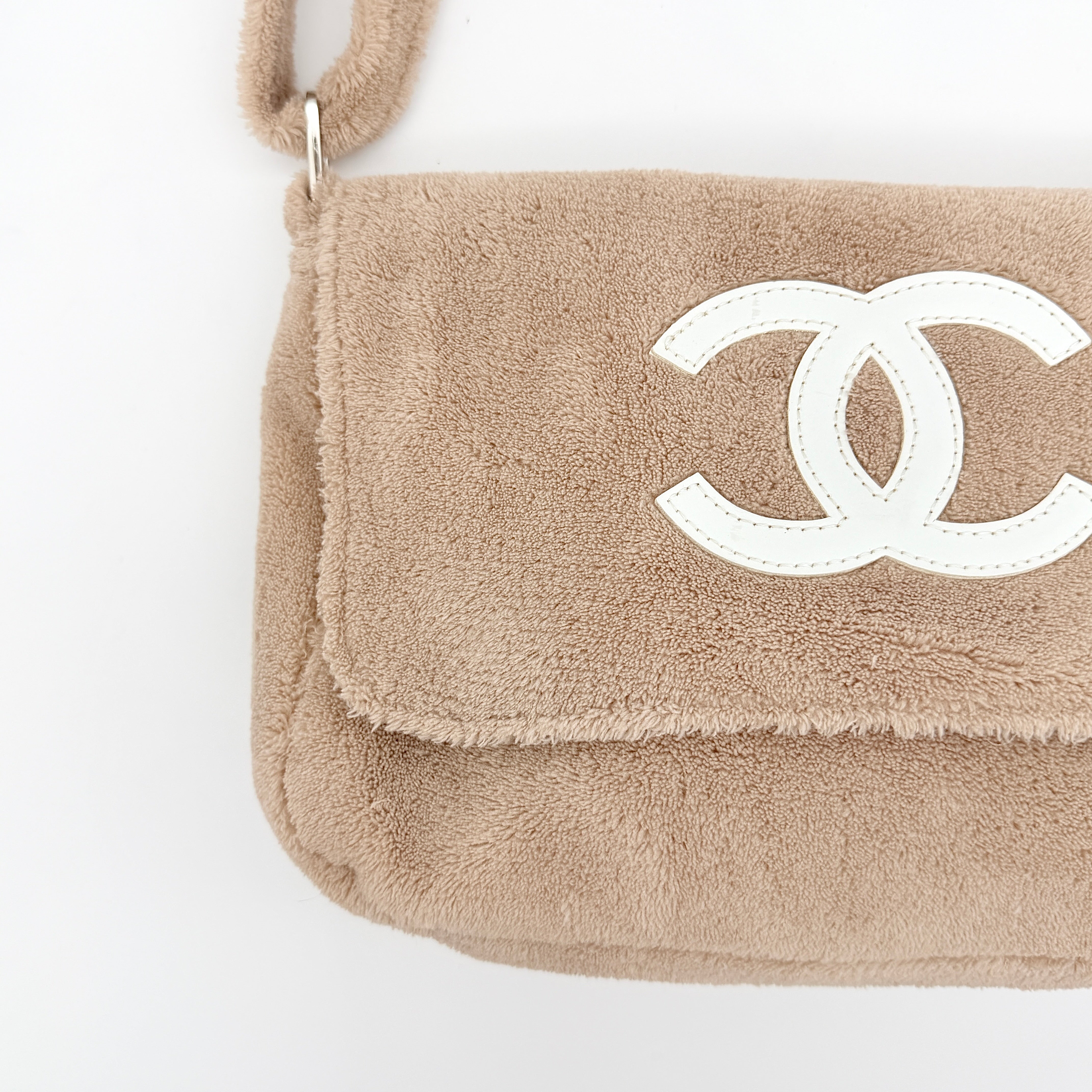 Chanel CC Precision Fragrance Line crossbody bag in beige terry cloth with white logo, shown with long strap.