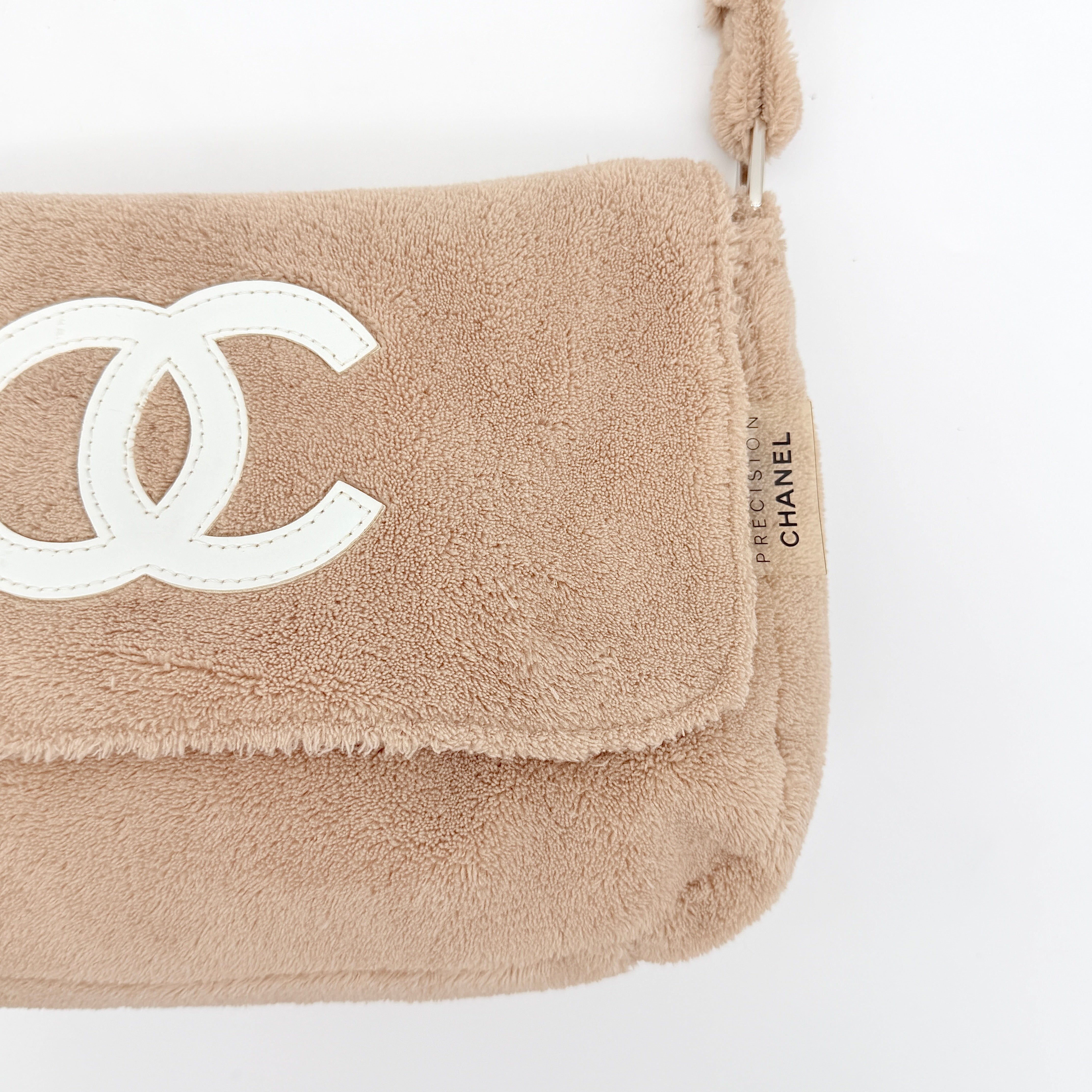 Chanel CC Precision Fragrance Line crossbody bag in beige terry cloth with white logo, shown with long strap.