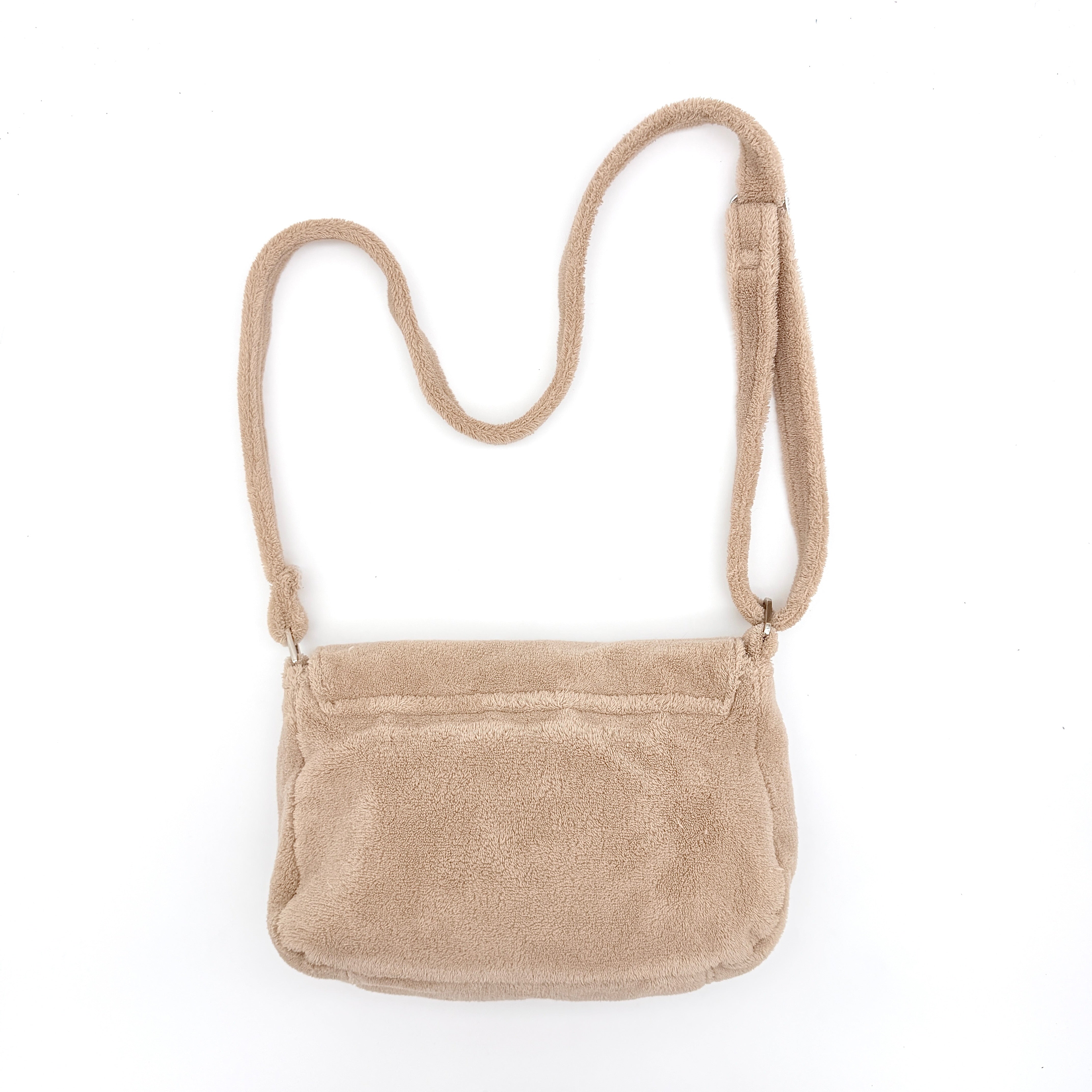 Chanel CC Precision Fragrance Line crossbody bag in beige terry cloth with white logo, shown with long strap.