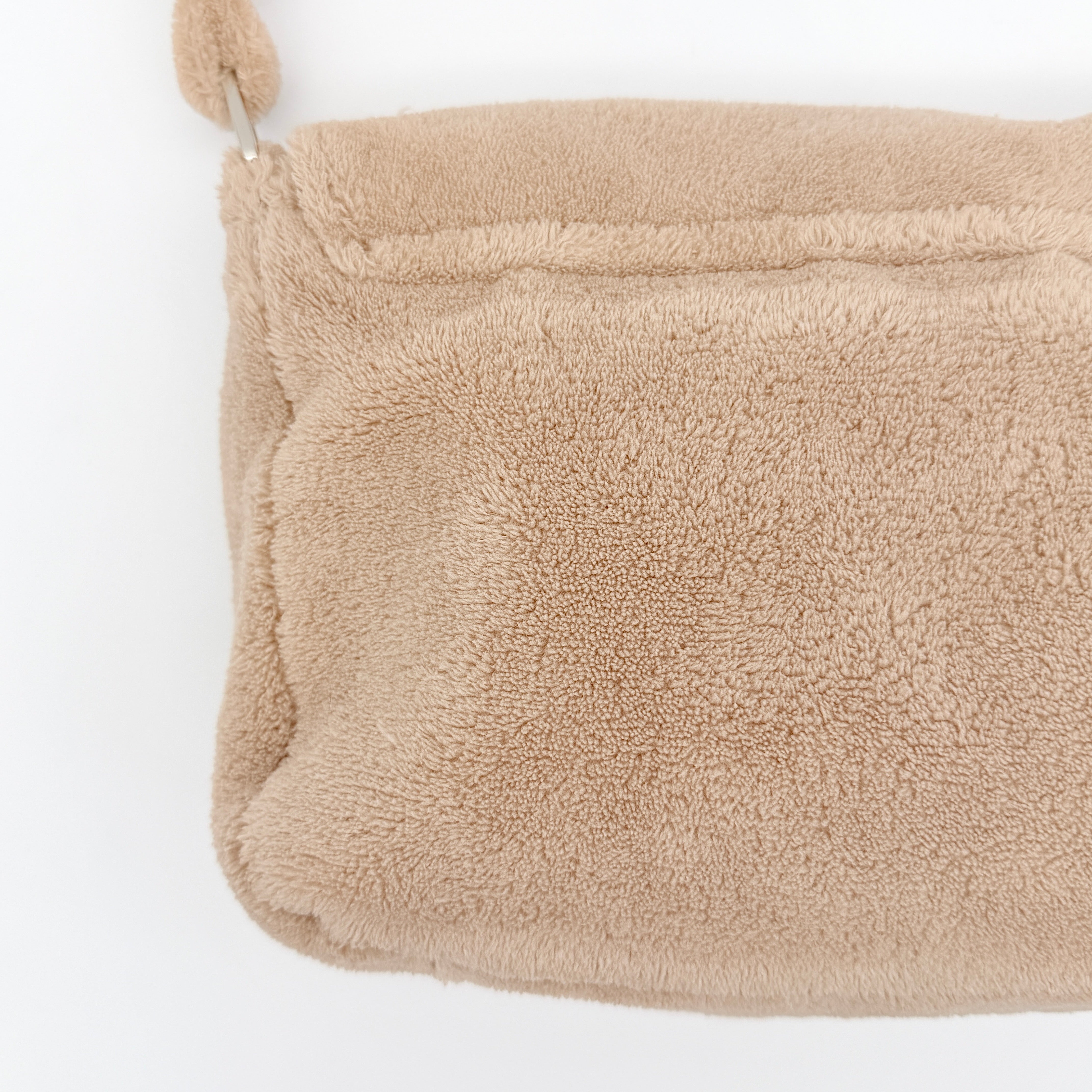 Chanel CC Precision Fragrance Line crossbody bag in beige terry cloth with white logo, shown with long strap.