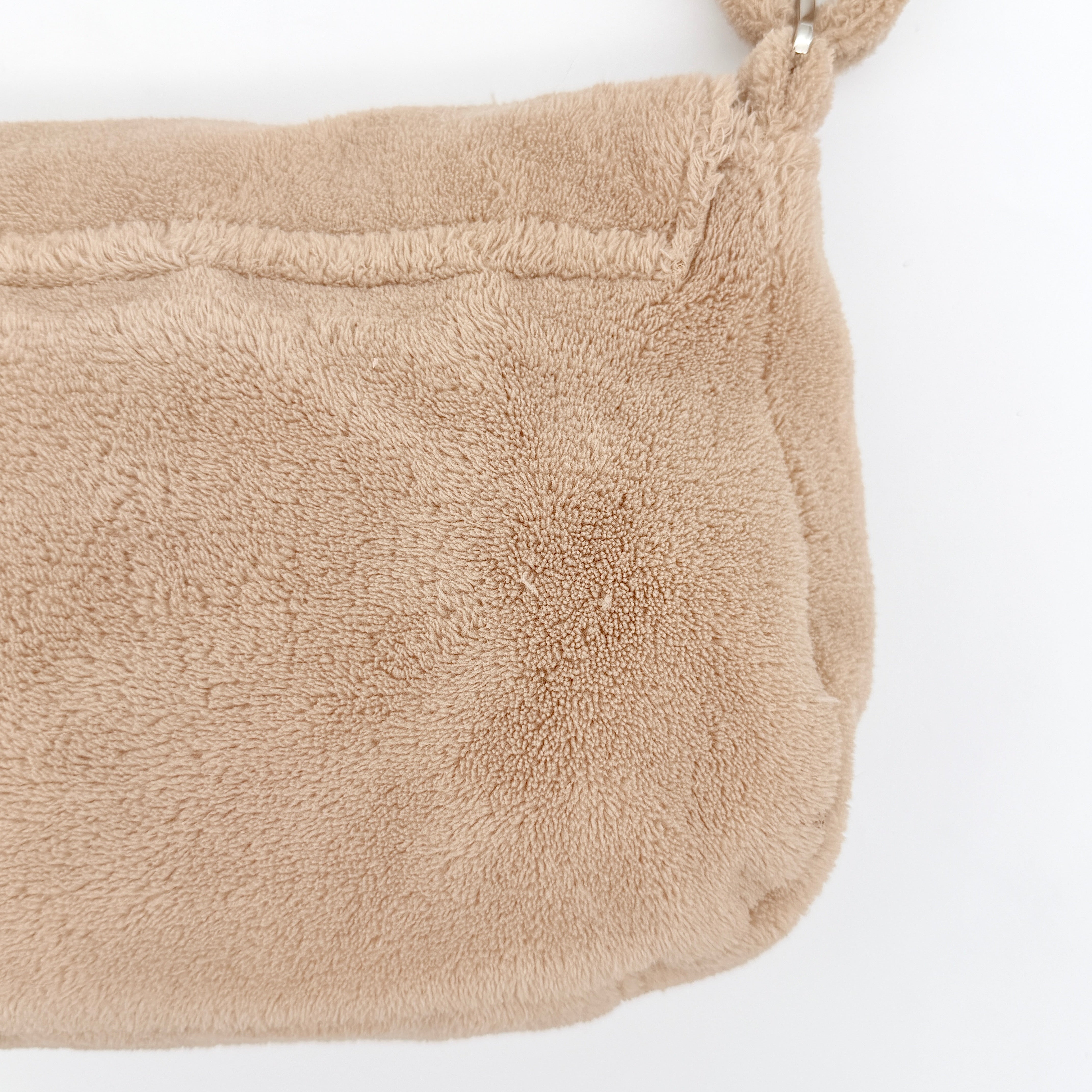 Chanel CC Precision Fragrance Line crossbody bag in beige terry cloth with white logo, shown with long strap.