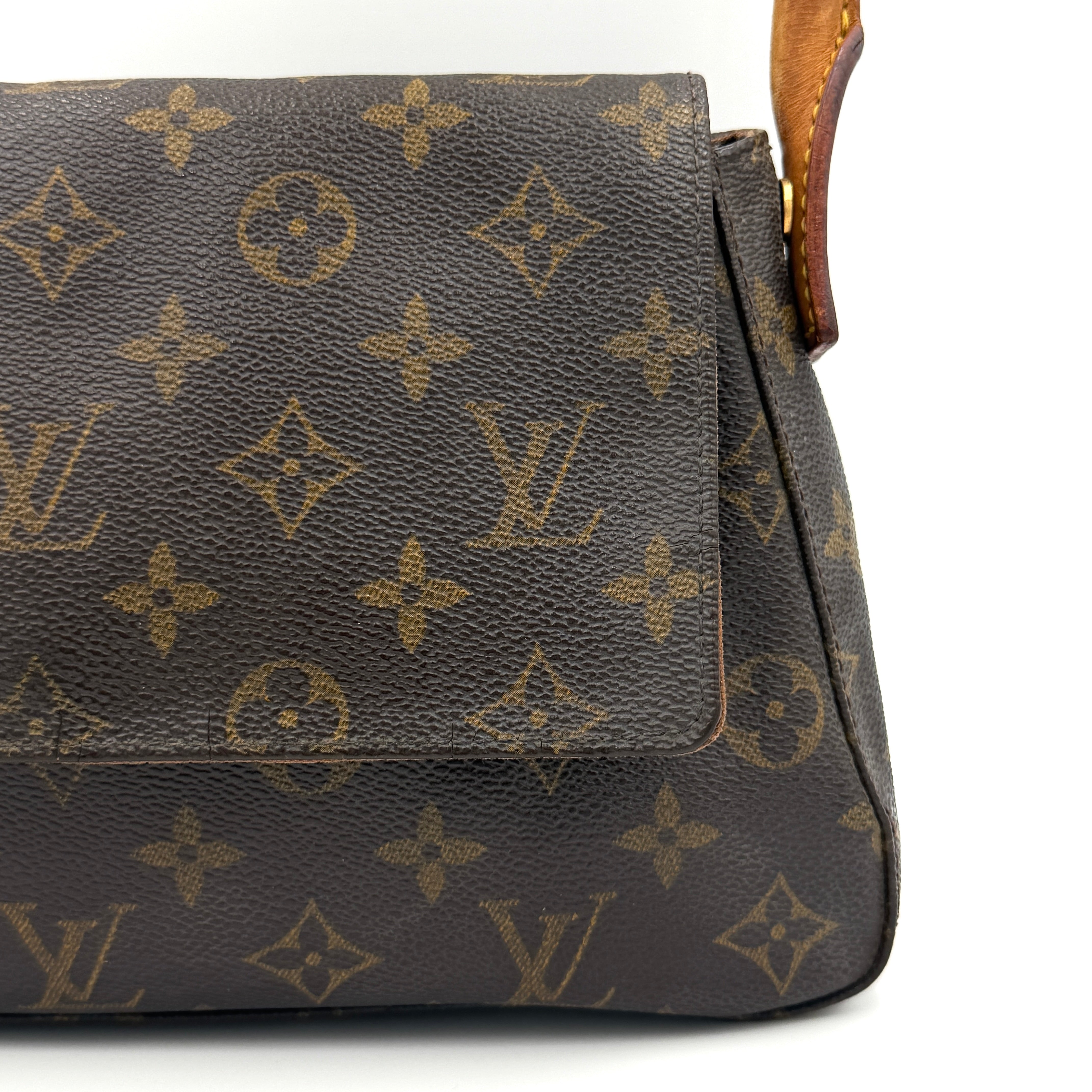 Louis Vuitton Monogram Mini Looping Shoulder Bag in brown monogram canvas with curved vachetta leather shoulder strap displayed upright.
