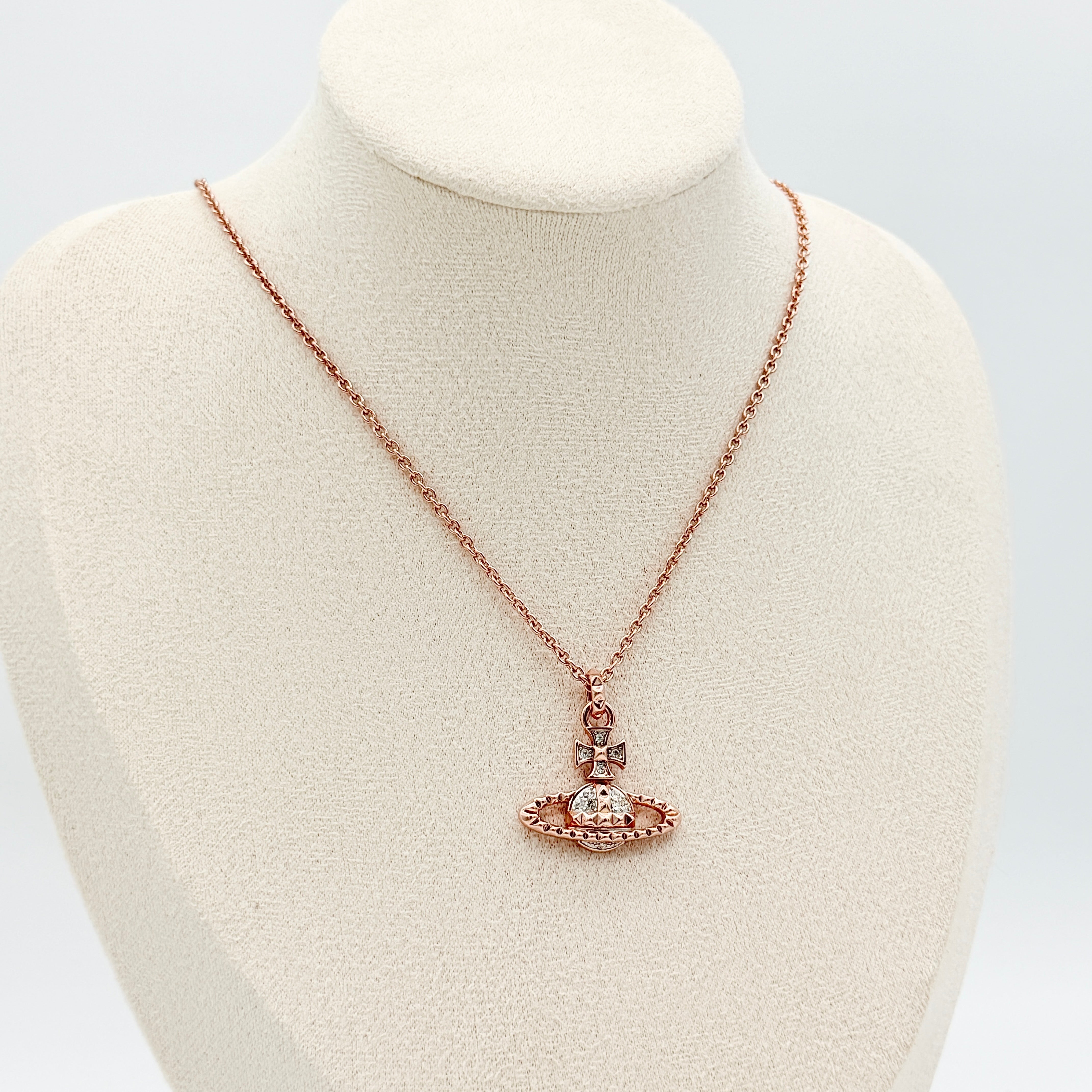 Vivienne Westwood rose gold Orb necklace with rhinestone accents displayed on a white background.