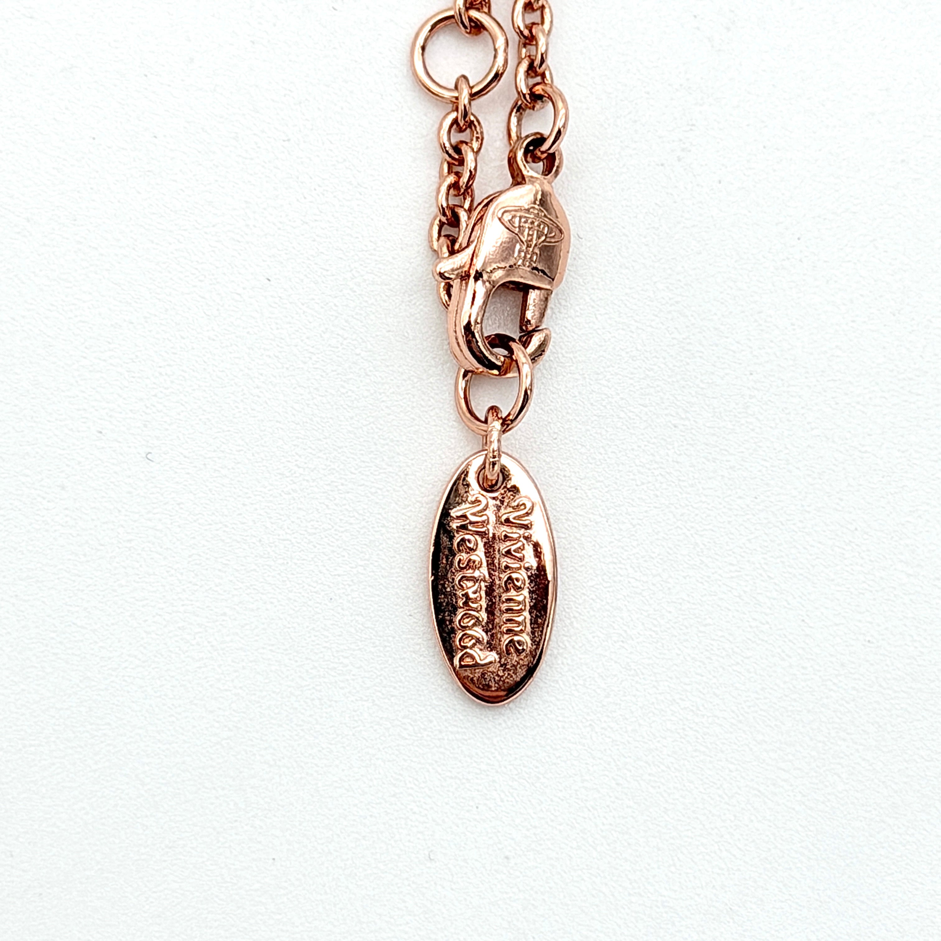 Vivienne Westwood rose gold Orb necklace with rhinestone accents displayed on a white background.