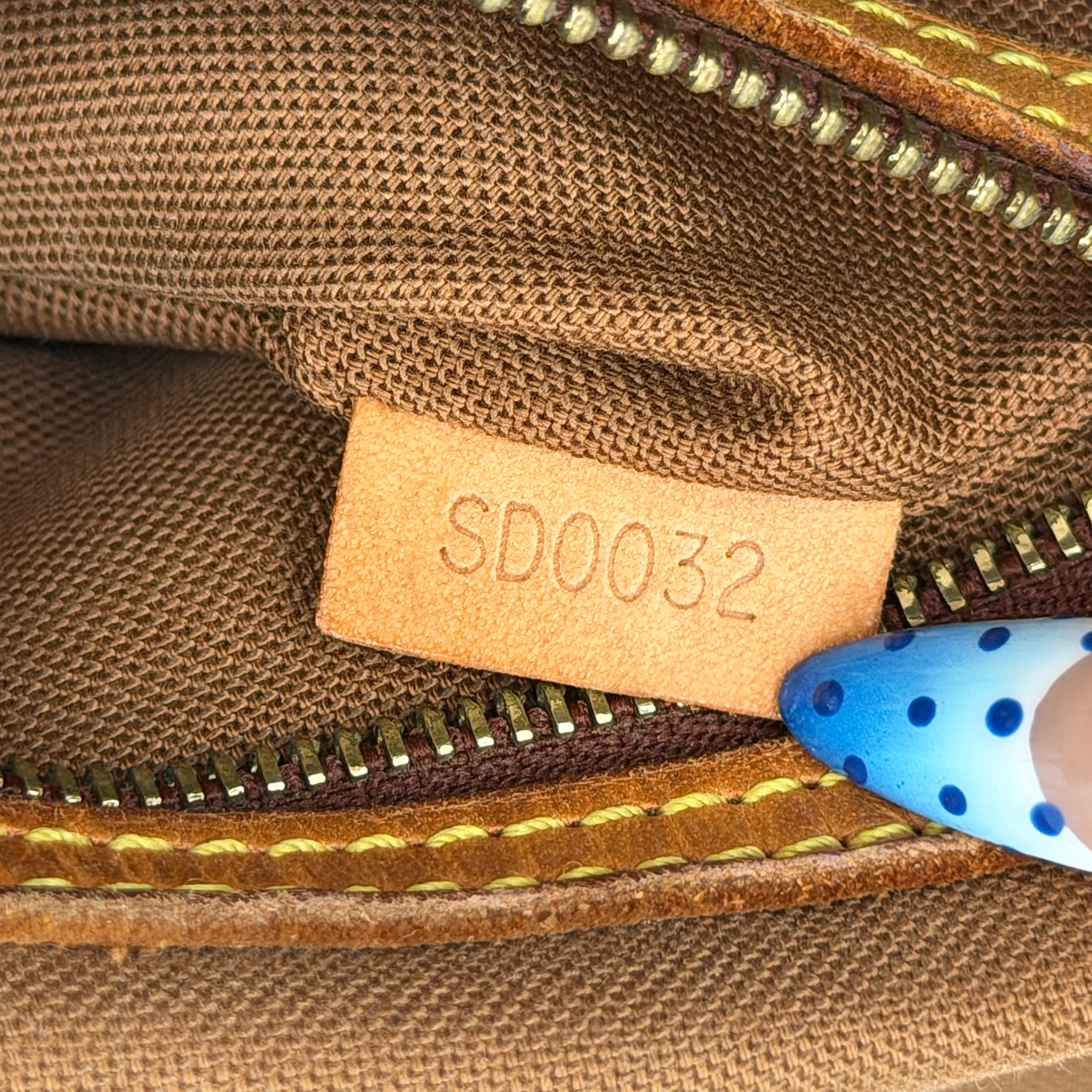 Louis Vuitton Monogram Mini Looping Shoulder Bag in brown monogram canvas with curved vachetta leather shoulder strap displayed upright.