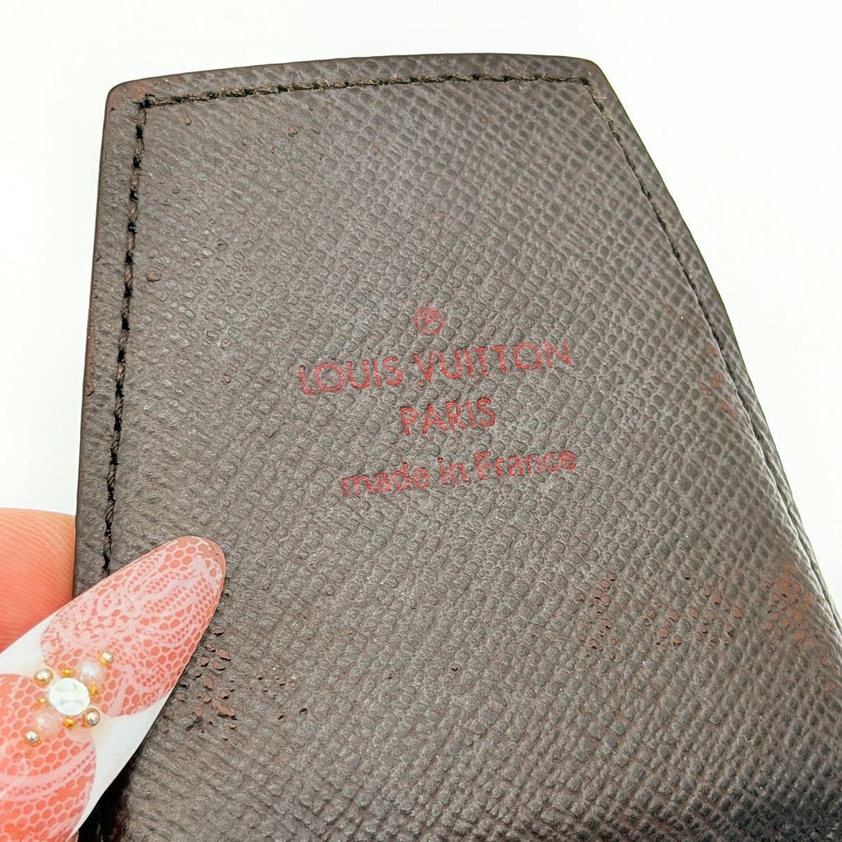Louis Vuitton Damier Monogram Cigarette Case in brown coated canvas with flap closure, photographed on a white background.