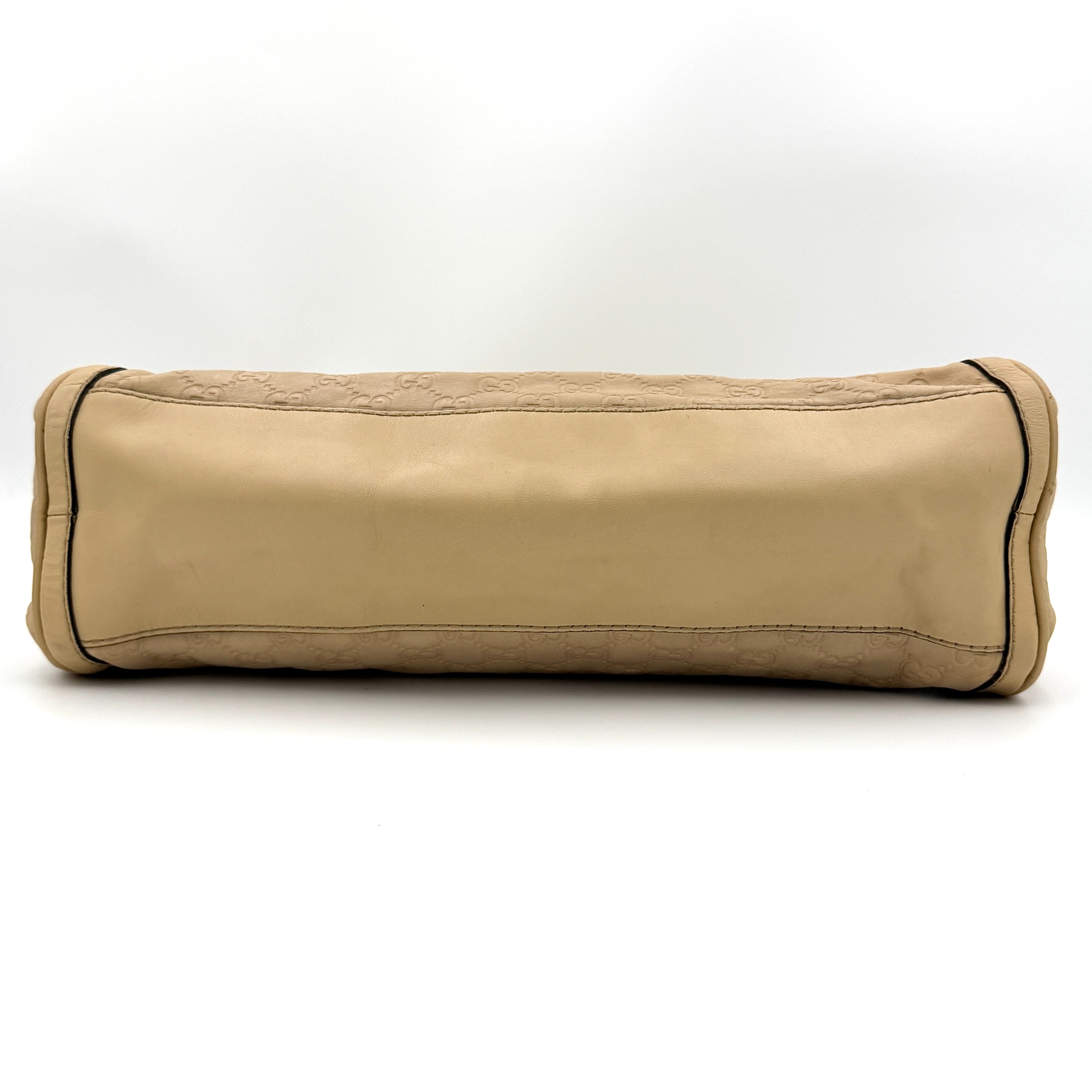 Gucci GG Monogram Guccissima Scarlett Shoulder Bag in beige embossed leather with gold hardware and single top handle.