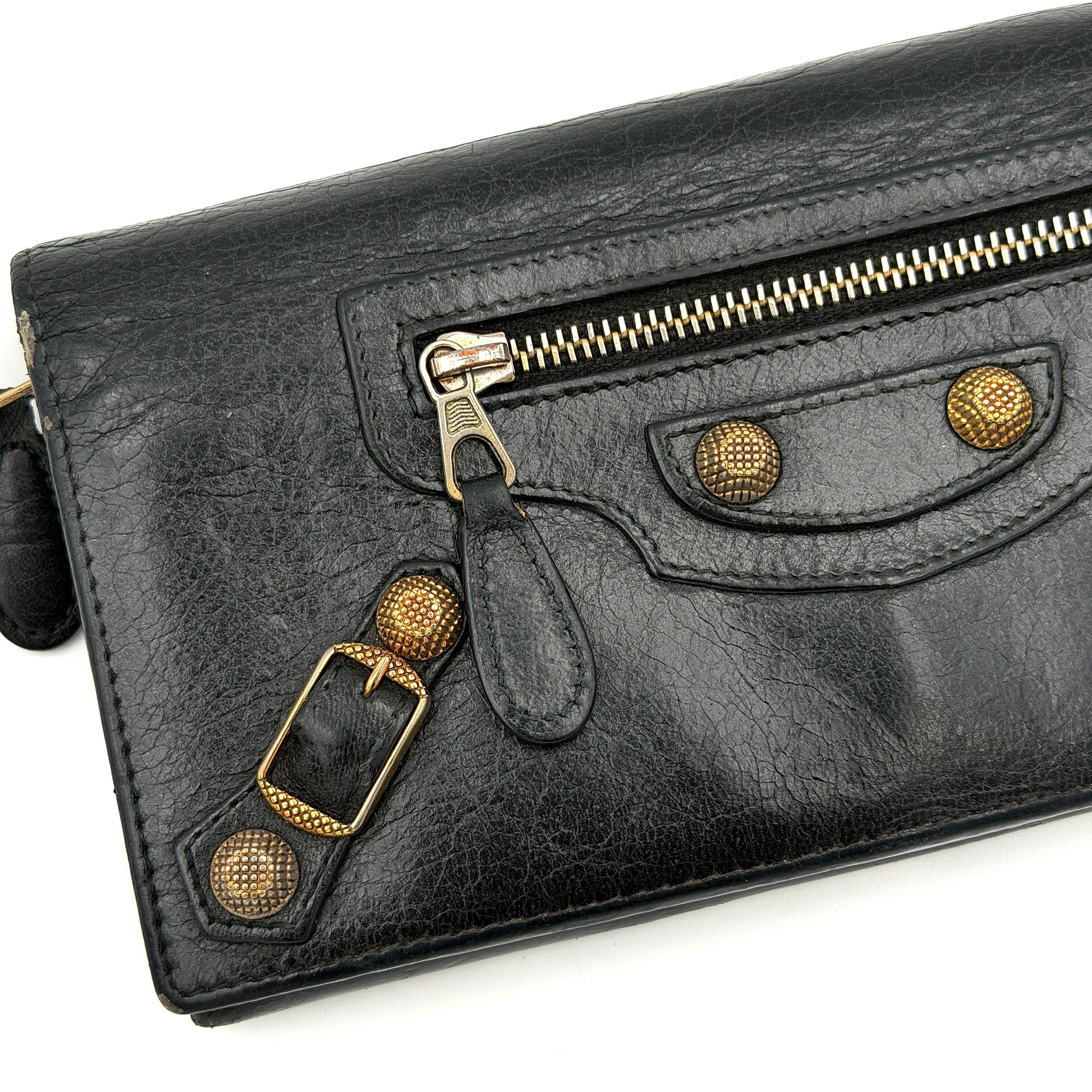 Balenciaga Motorcycle Studded Long Wallet in black distressed leather with signature brass studs and buckle details.