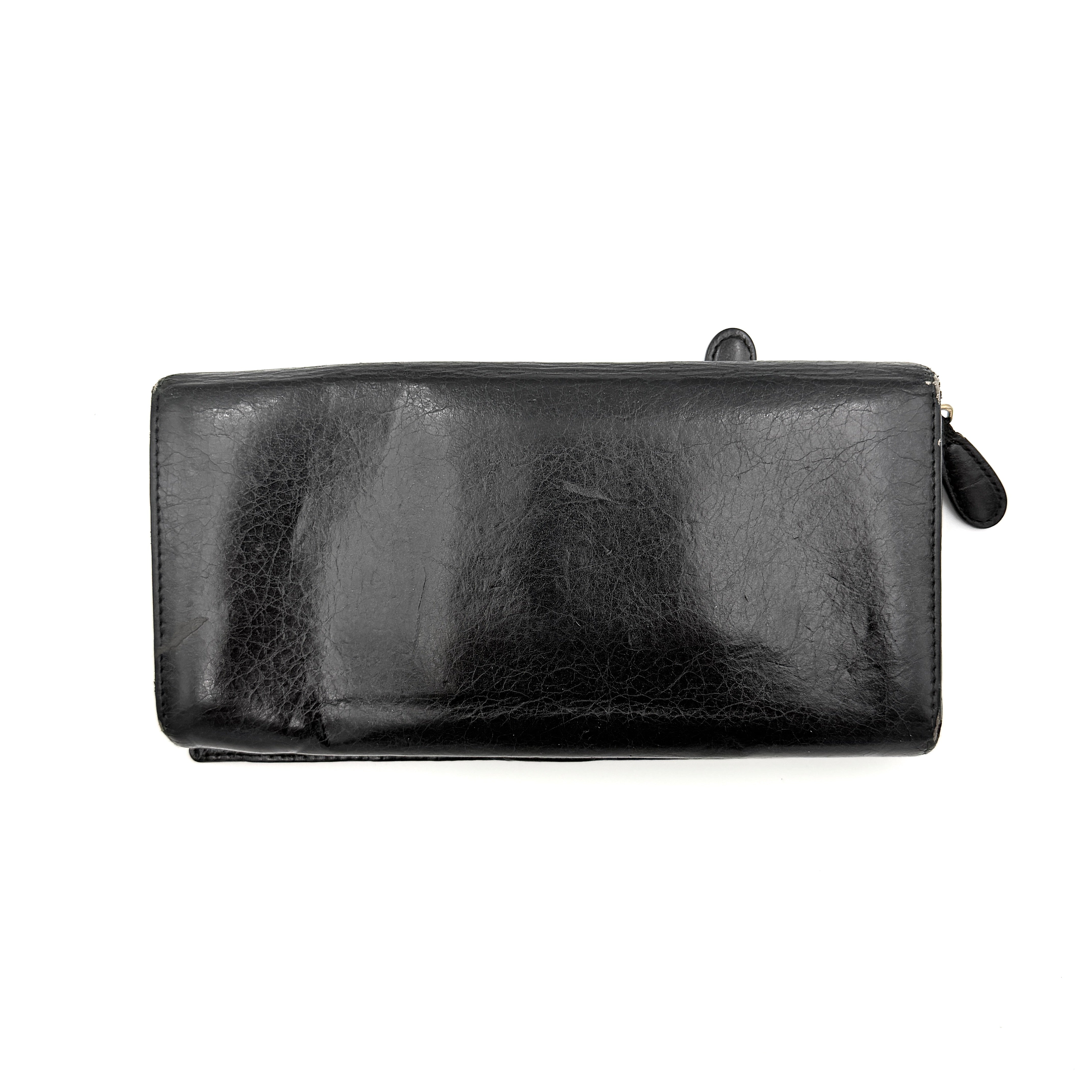 Balenciaga Motorcycle Studded Long Wallet in black distressed leather with signature brass studs and buckle details.