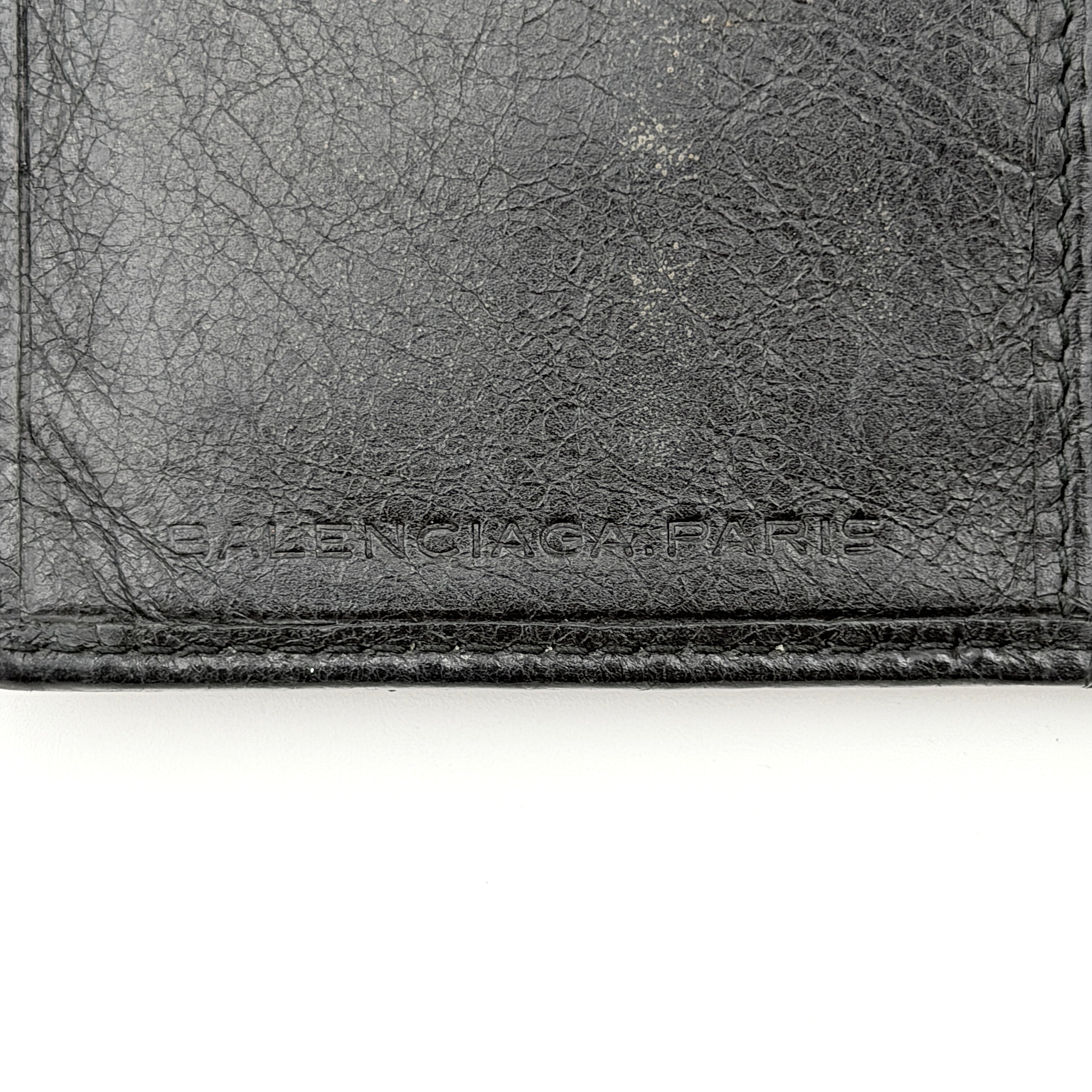 Balenciaga Motorcycle Studded Long Wallet in black distressed leather with signature brass studs and buckle details.