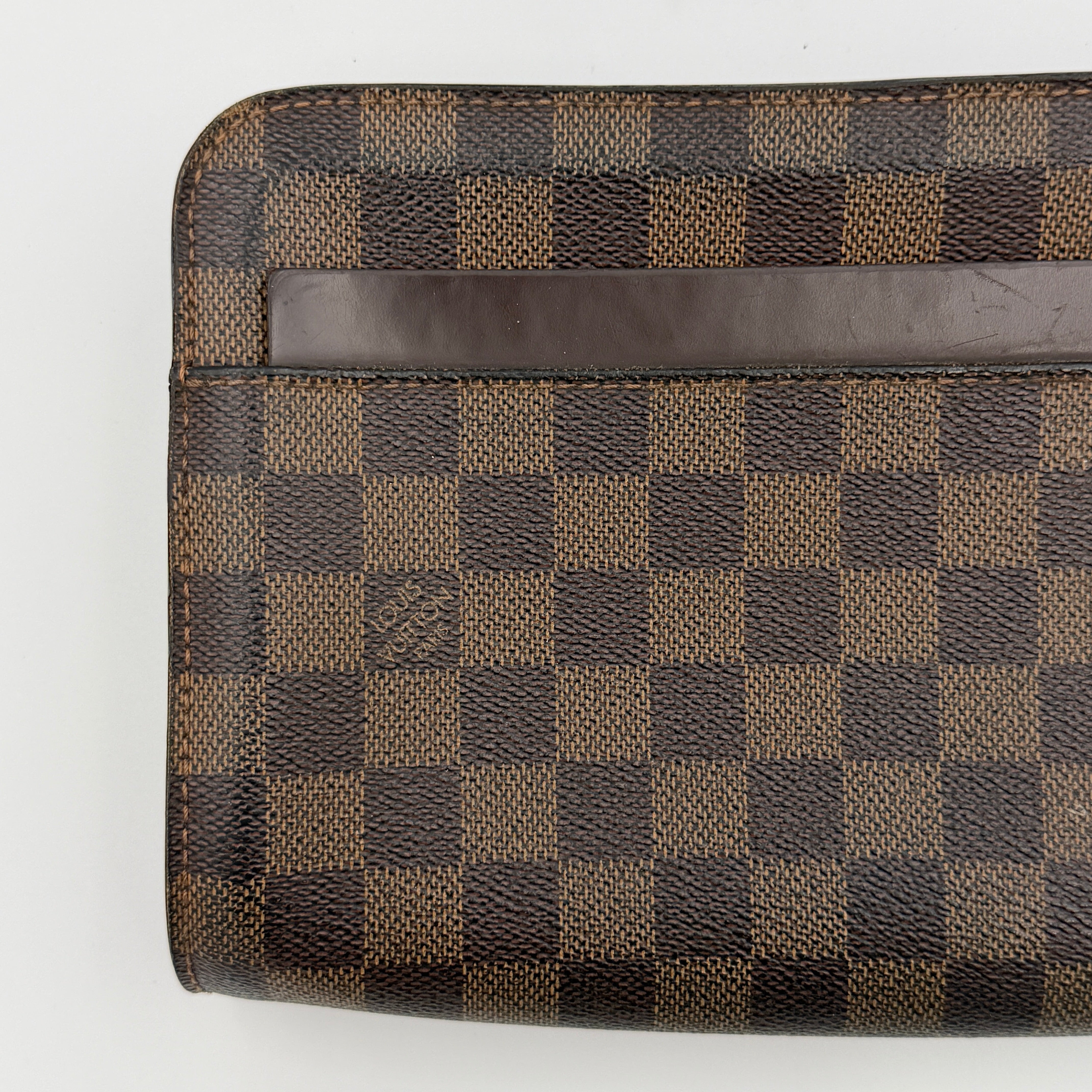 Louis Vuitton Saint Louis Damier Clutch Bag in brown Damier Ebene canvas with chocolate leather trim and gold-tone hardware, photographed on white background.