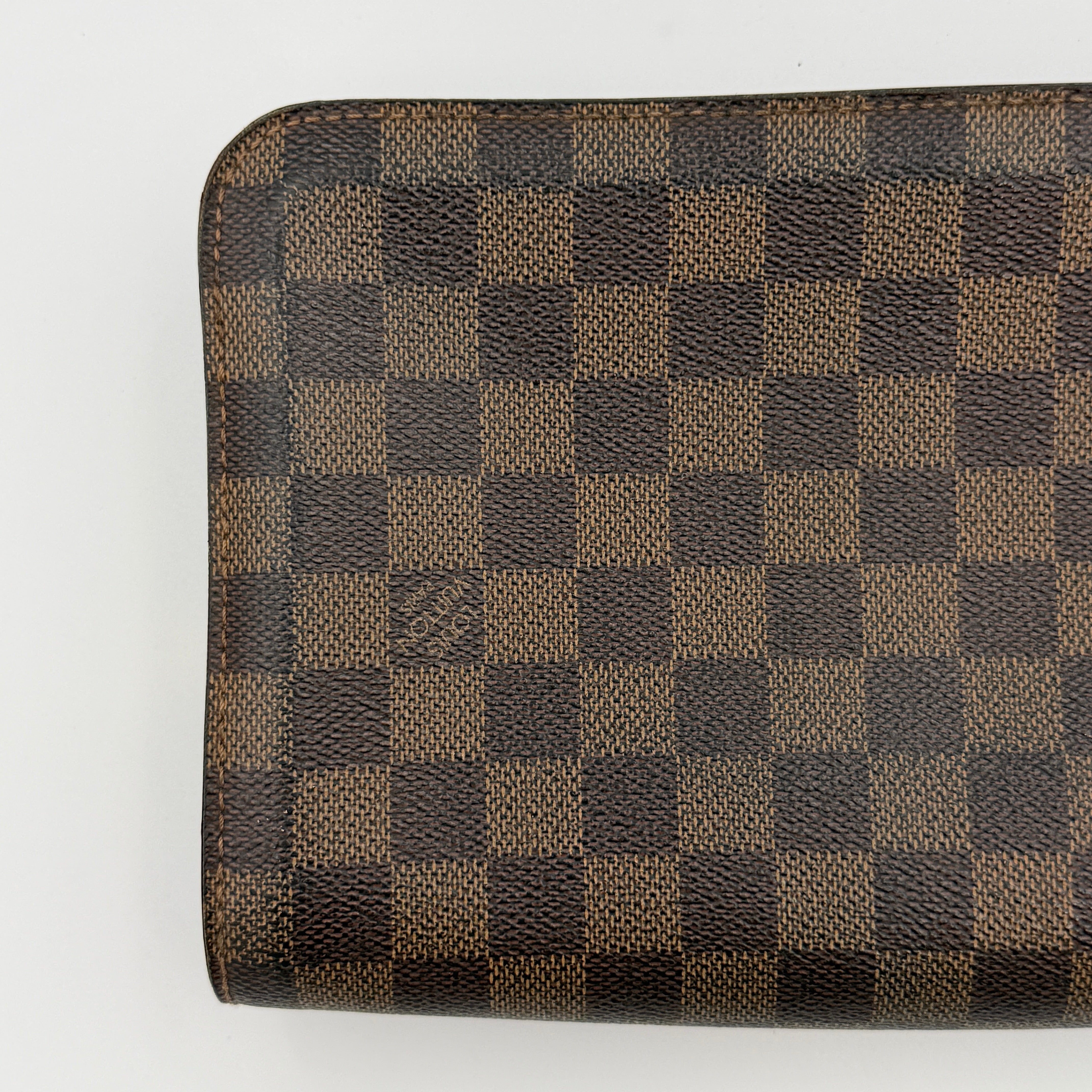 Louis Vuitton Saint Louis Damier Clutch Bag in brown Damier Ebene canvas with chocolate leather trim and gold-tone hardware, photographed on white background.