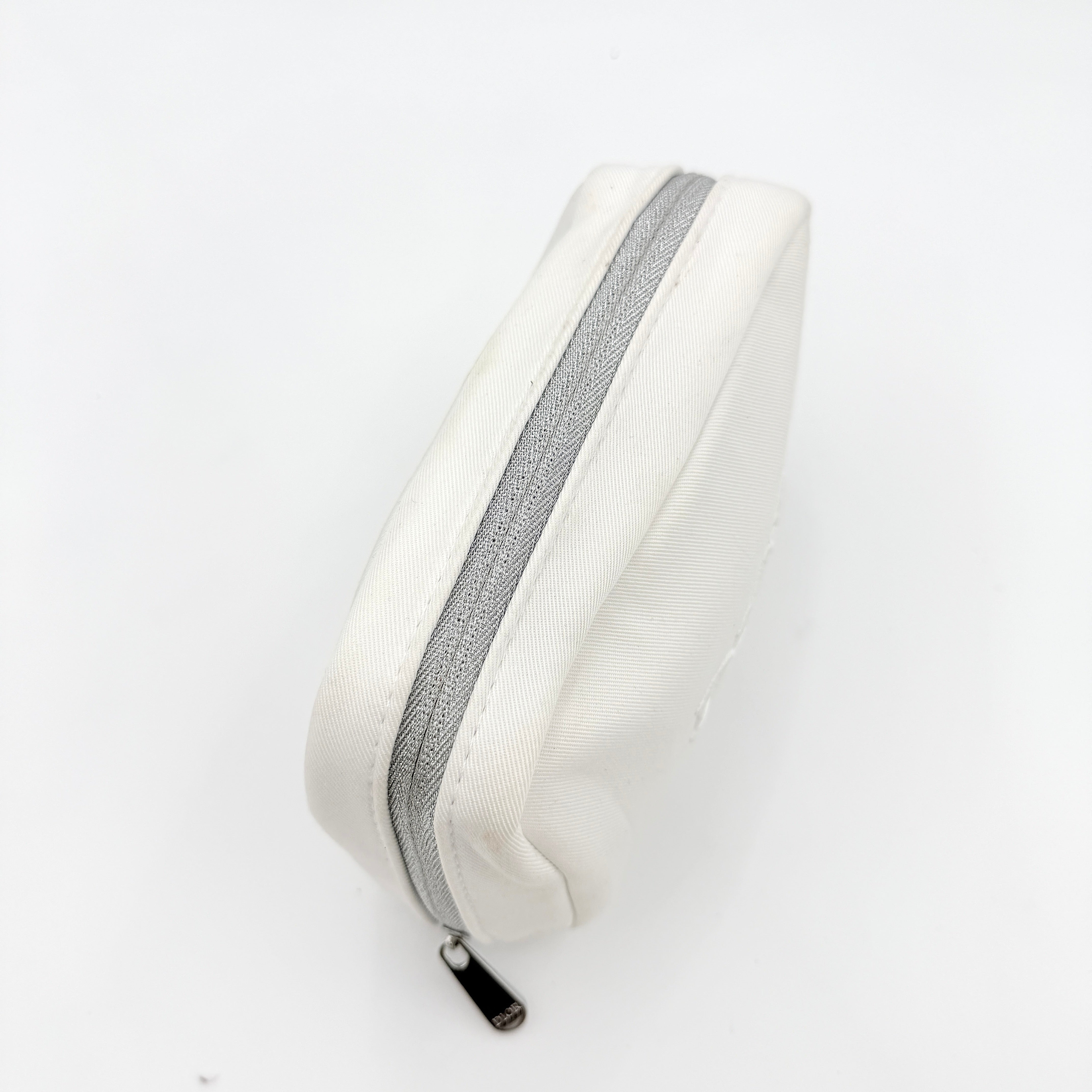 Crisp white Dior Beauty Logo Pouch with an embroidered logo and sleek silver-tone zipper, showcased against a minimalist backdrop.