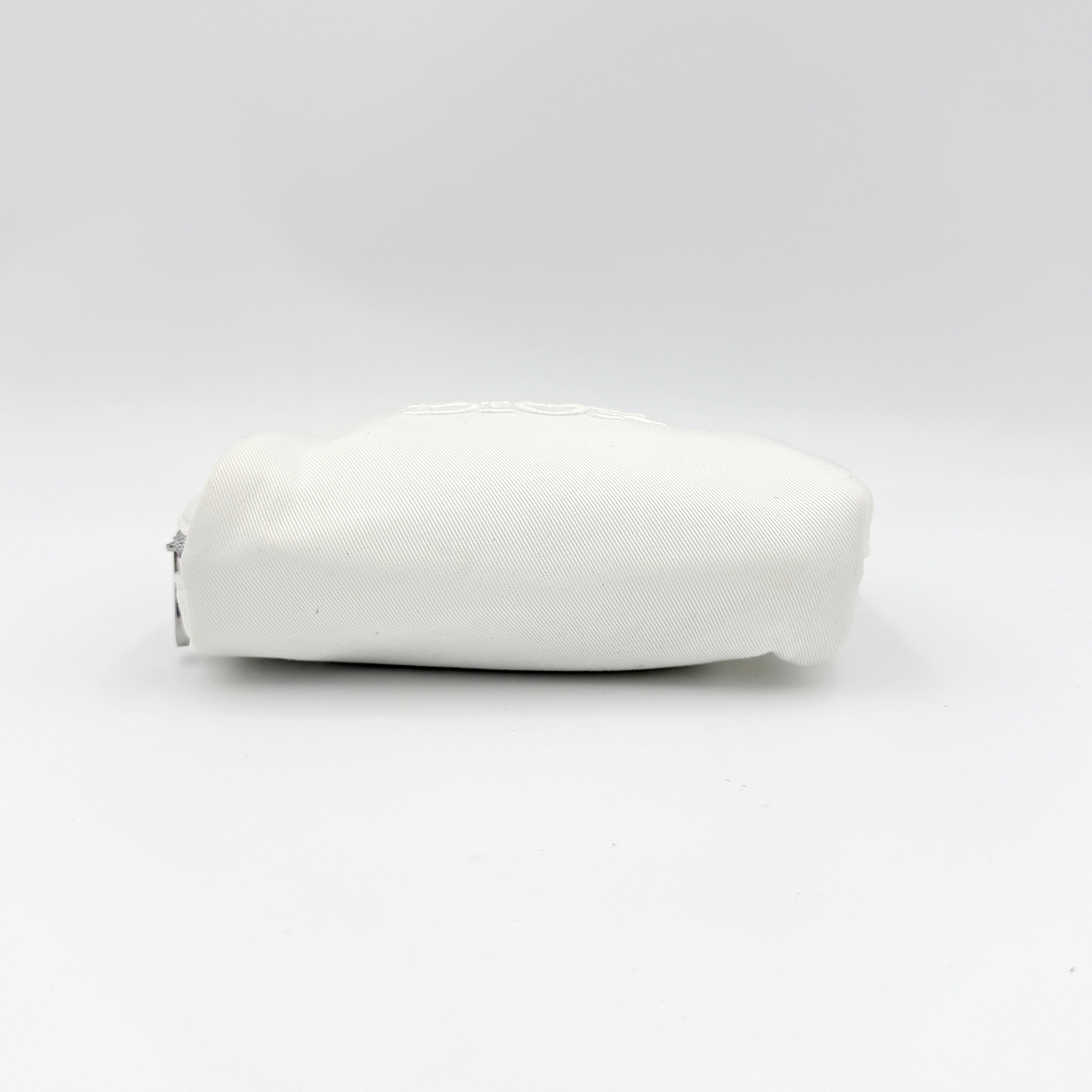 Crisp white Dior Beauty Logo Pouch with an embroidered logo and sleek silver-tone zipper, showcased against a minimalist backdrop.