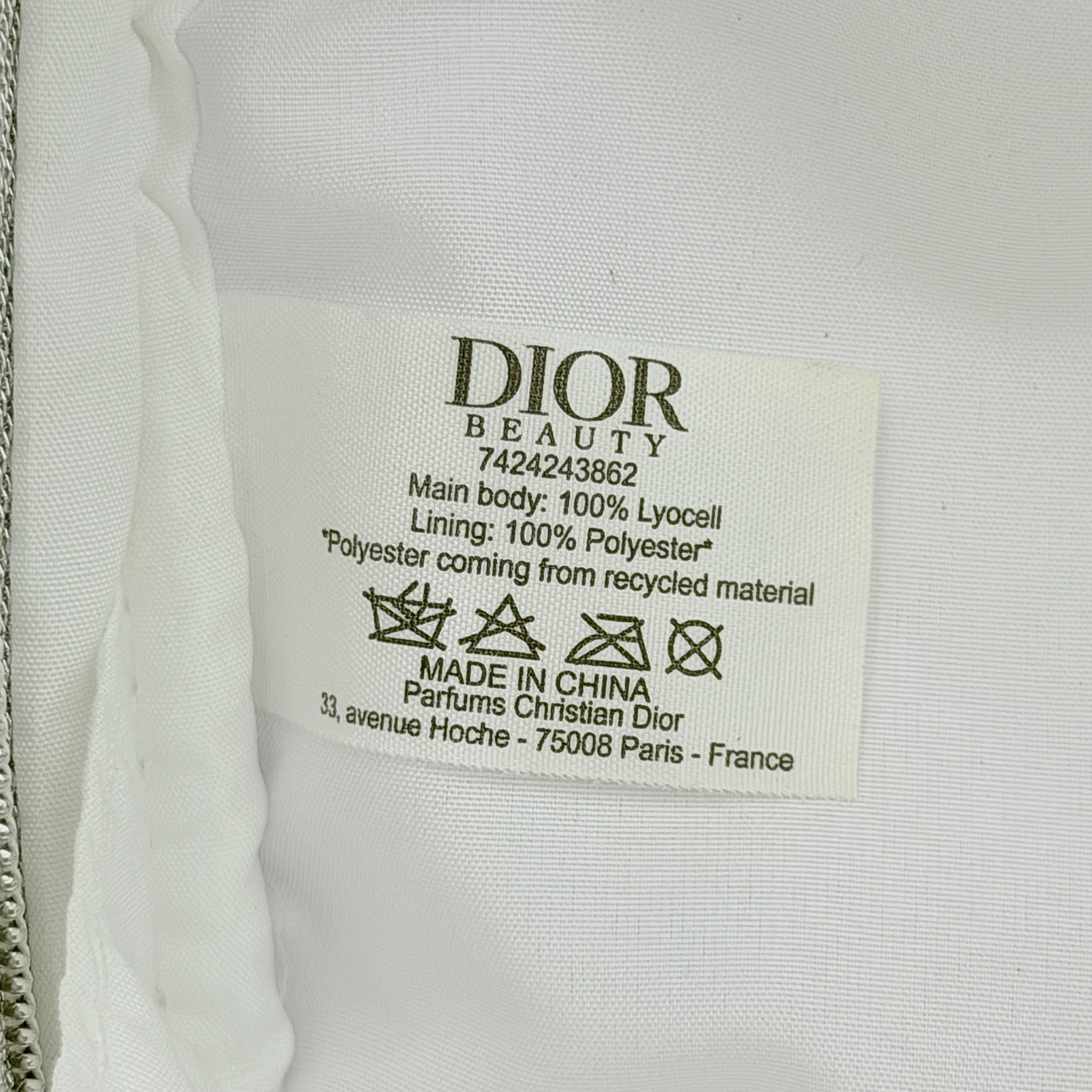 Crisp white Dior Beauty Logo Pouch with an embroidered logo and sleek silver-tone zipper, showcased against a minimalist backdrop.
