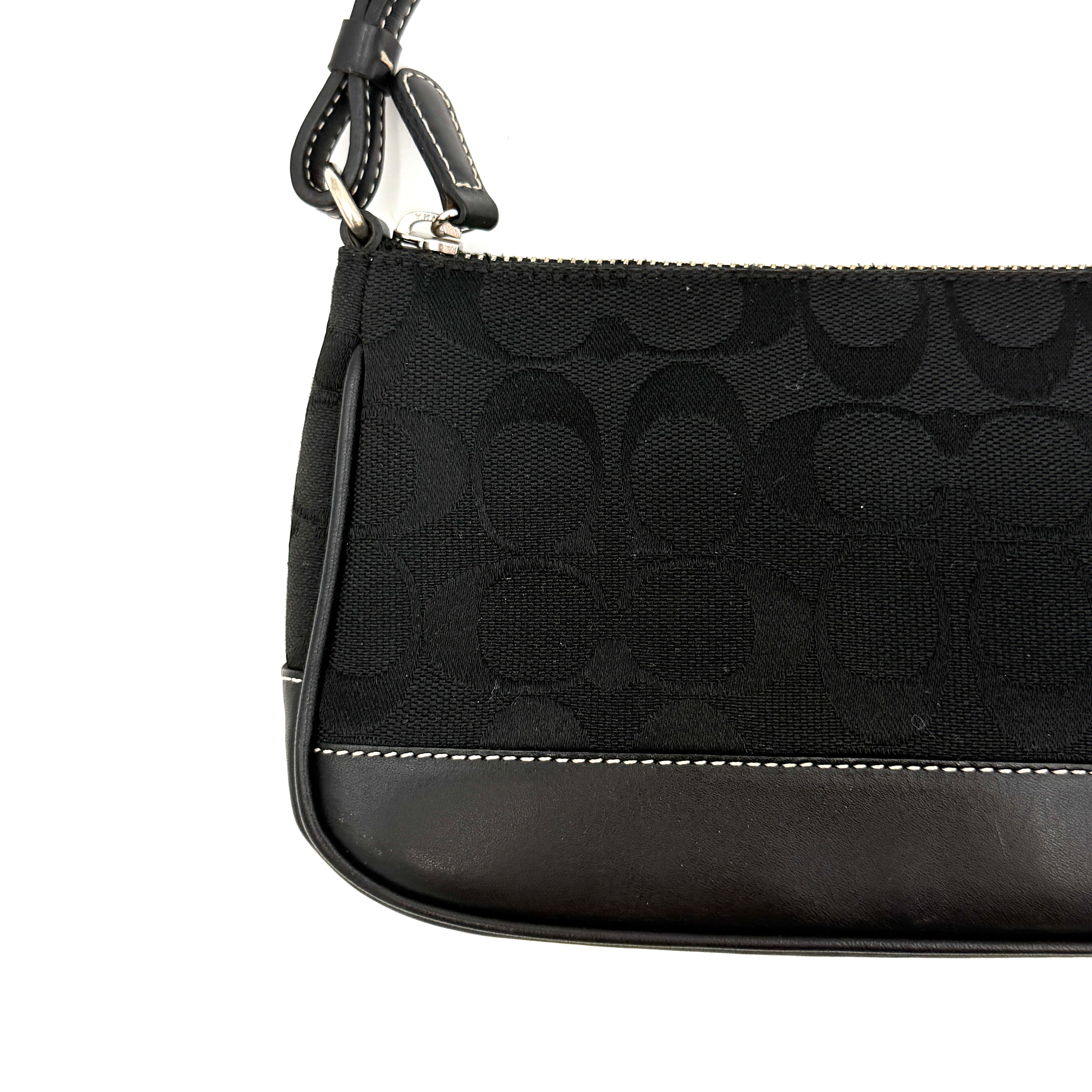 Coach Y2K Demi Shoulder Bag in black signature jacquard with leather trim, white topstitching, and silver hardware, shown with its classic tag.