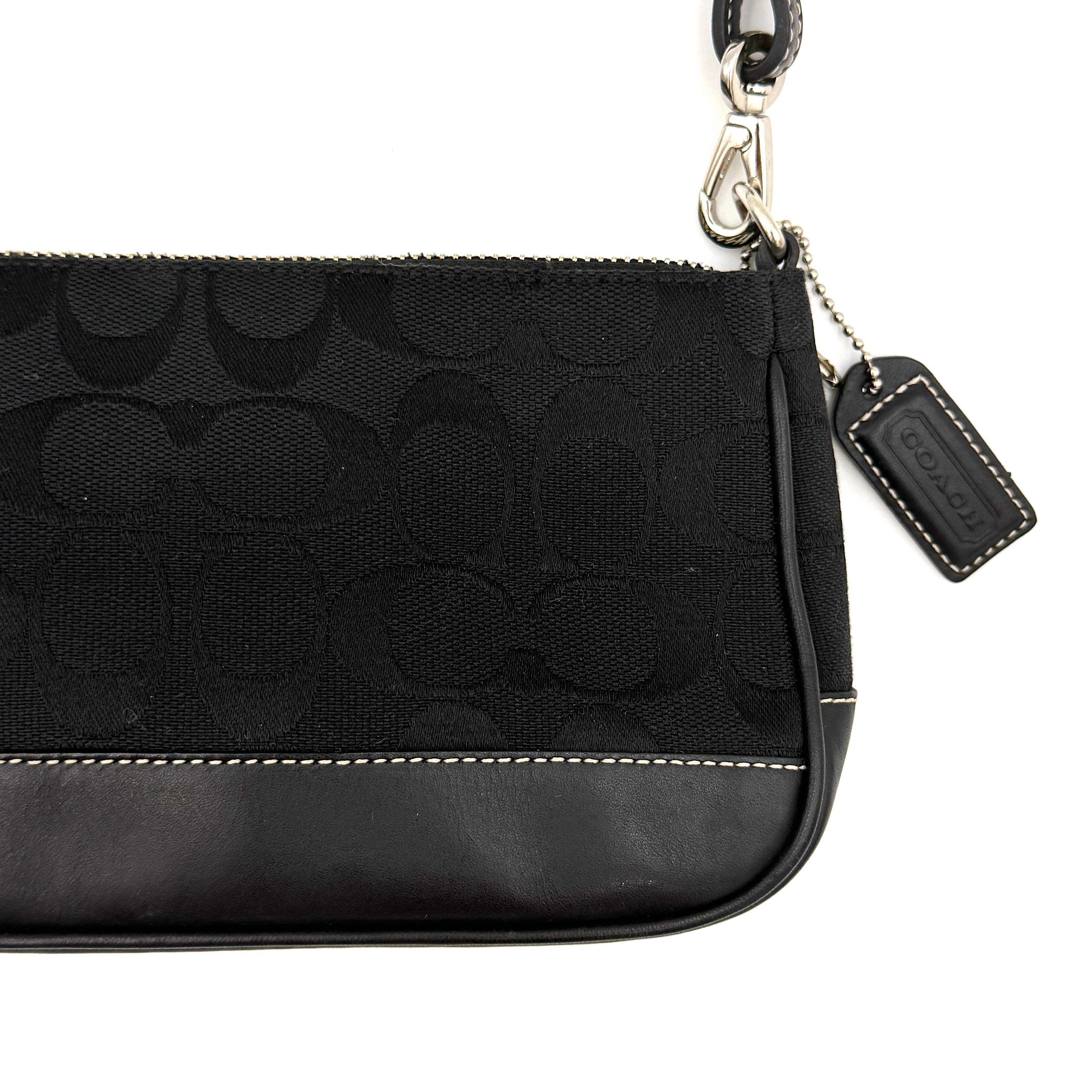 Coach Y2K Demi Shoulder Bag in black signature jacquard with leather trim, white topstitching, and silver hardware, shown with its classic tag.