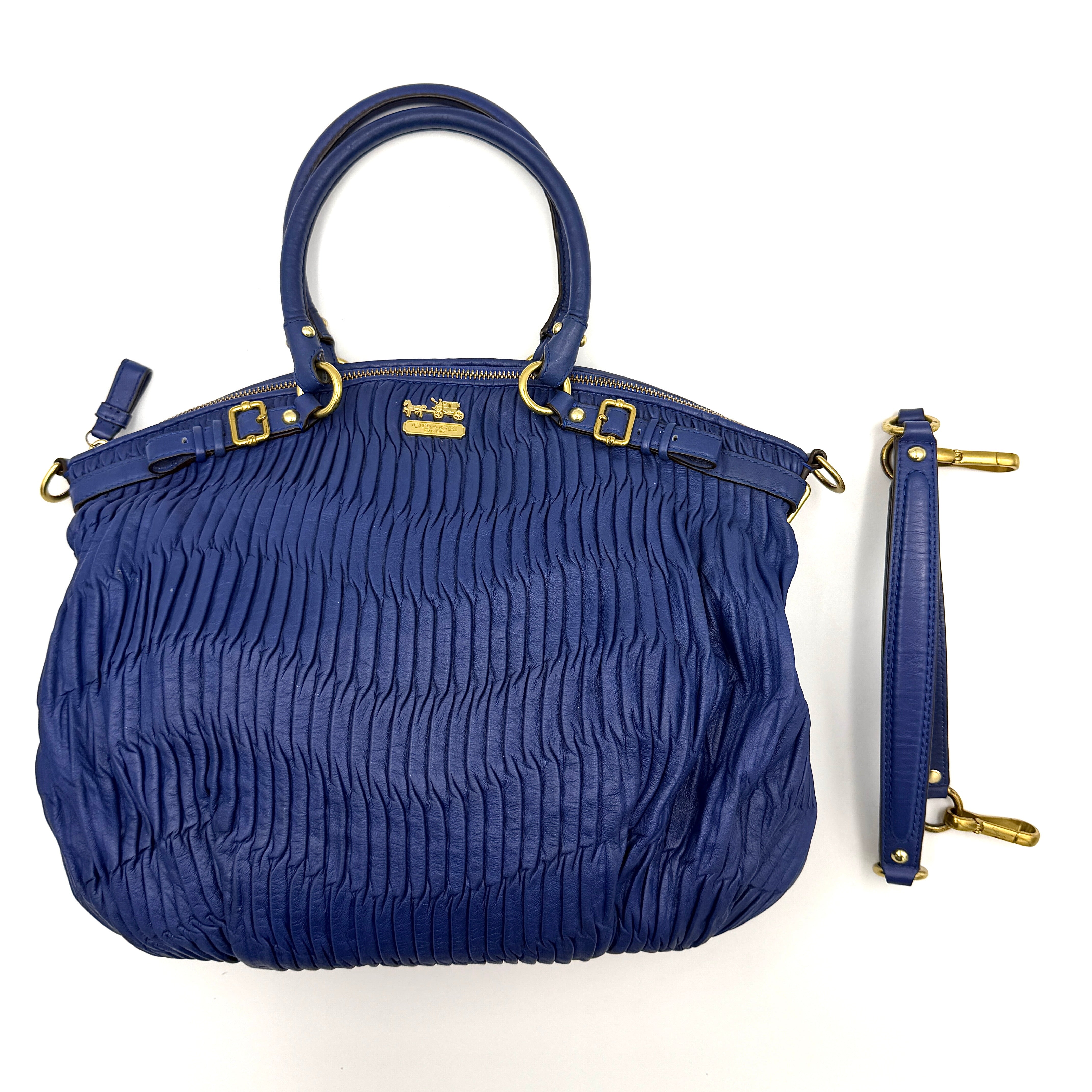 Coach Madison Shoulder Bag in gathered blue leather with gold-tone hardware and removable shoulder strap displayed against a white backdrop.