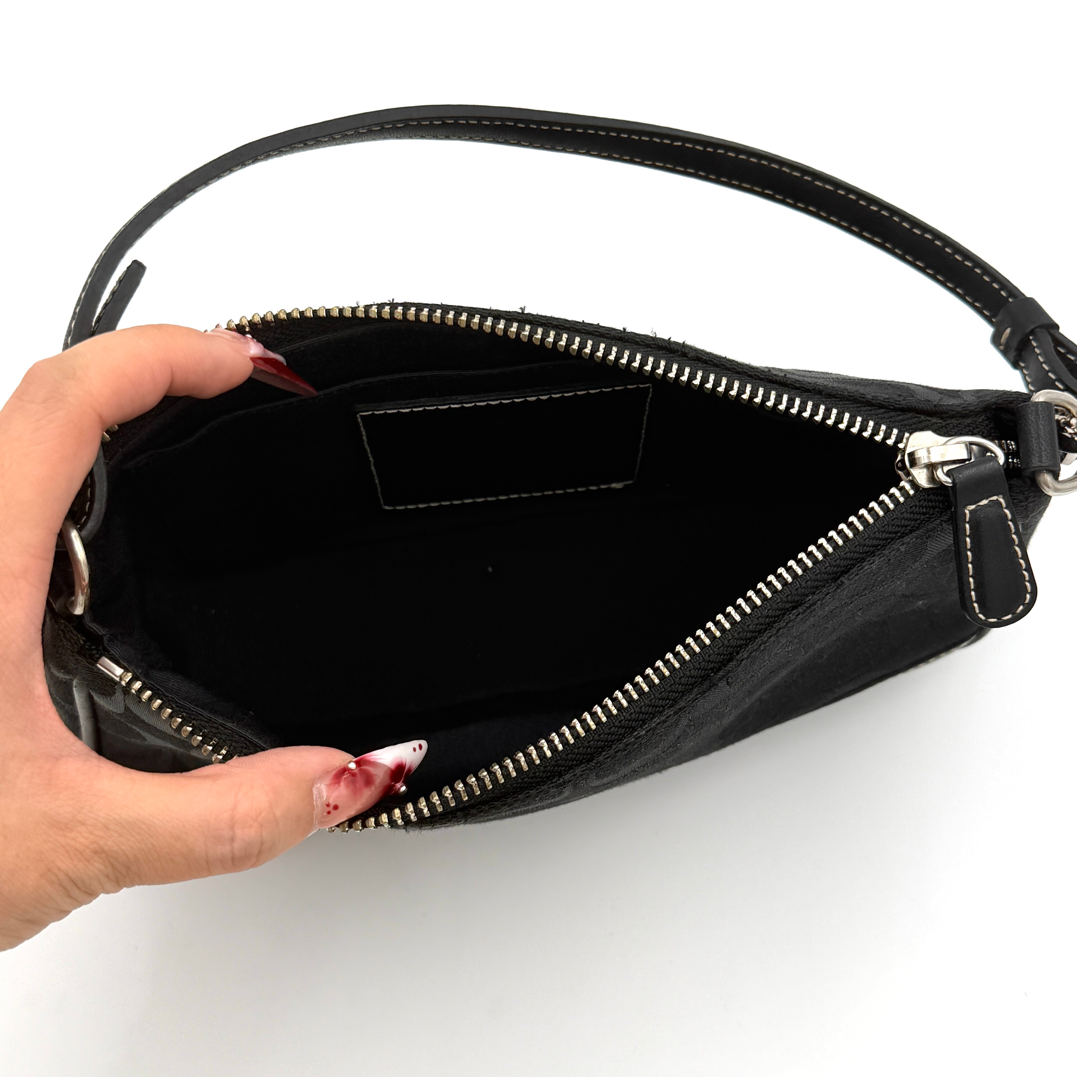 Coach Y2K Demi Shoulder Bag in black signature jacquard with leather trim, white topstitching, and silver hardware, shown with its classic tag.
