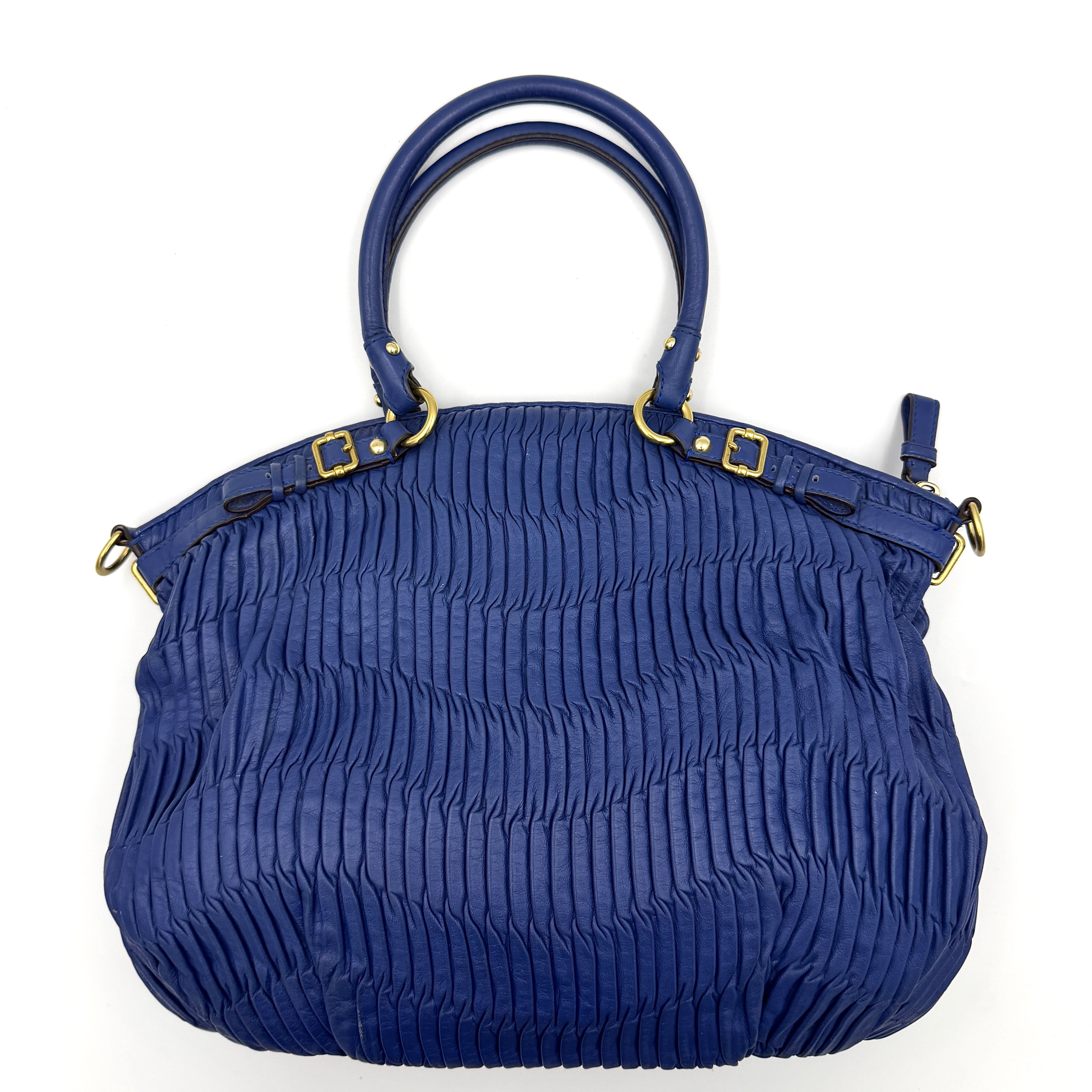 Coach Madison Shoulder Bag in gathered blue leather with gold-tone hardware and removable shoulder strap displayed against a white backdrop.