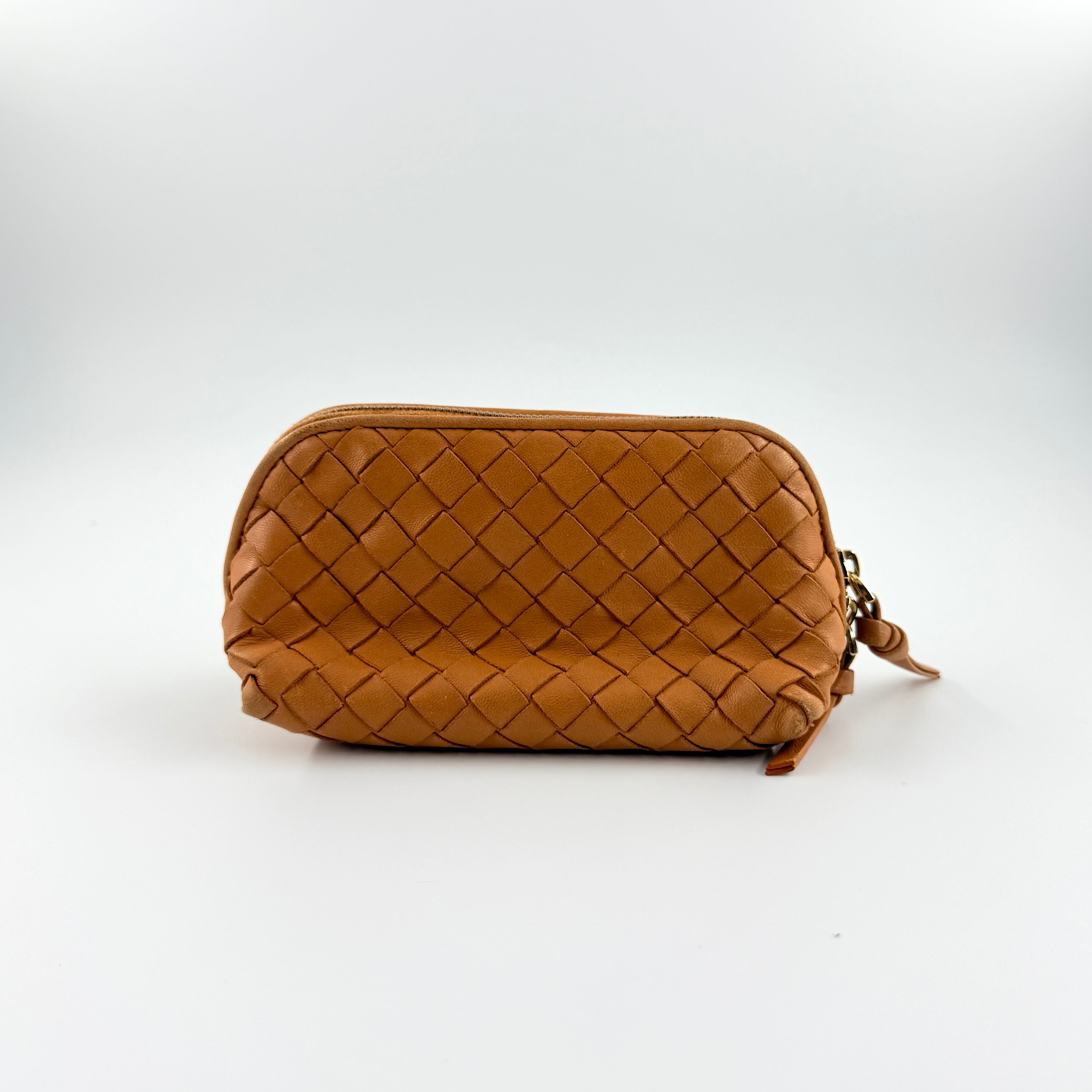 A Bottega Veneta brown Intrecciato leather pouch with gold zip and woven texture, displayed against a clean, minimal background.