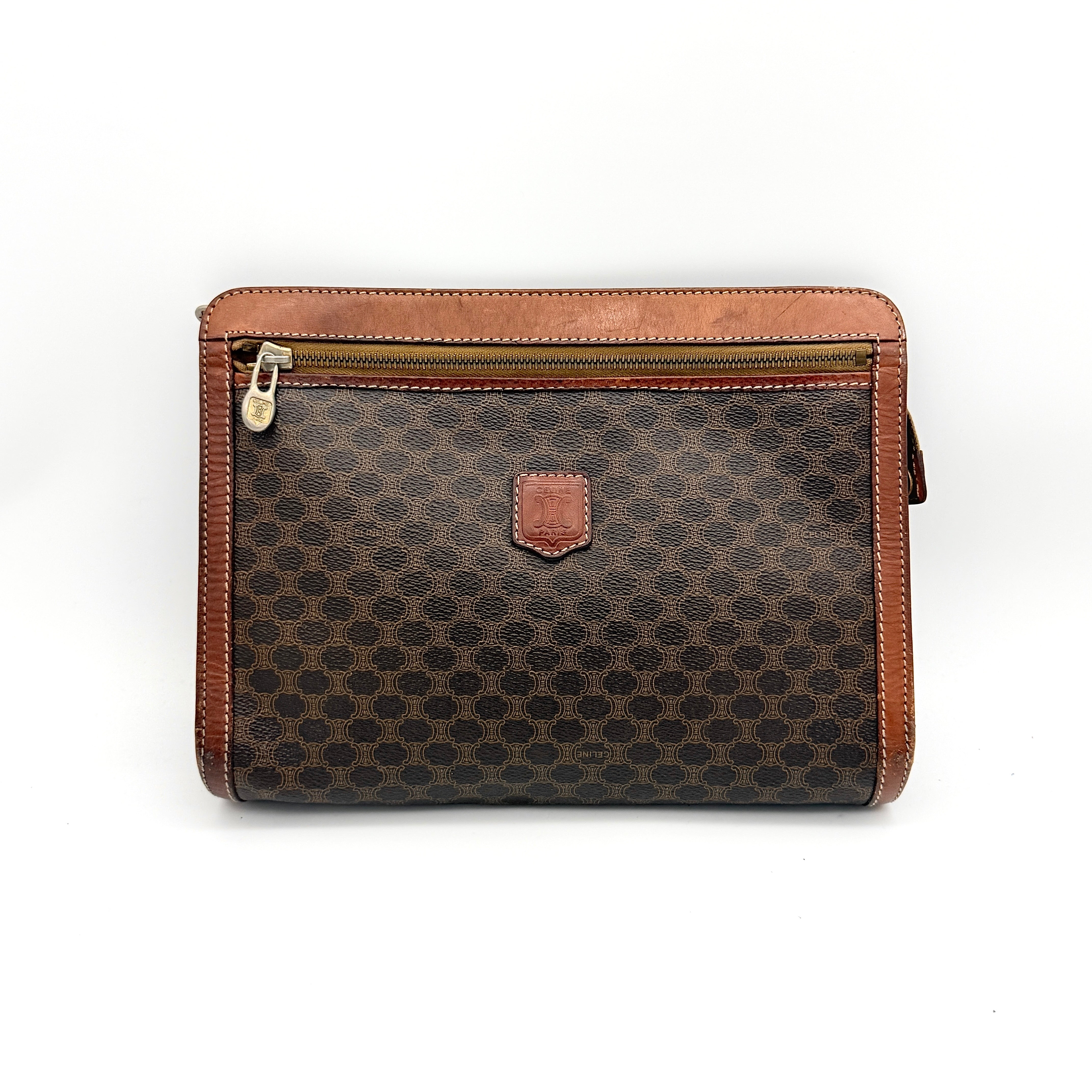 Front view of the Celine Triomphe Macadam clutch bag in brown canvas with tan leather trim and zip pocket.