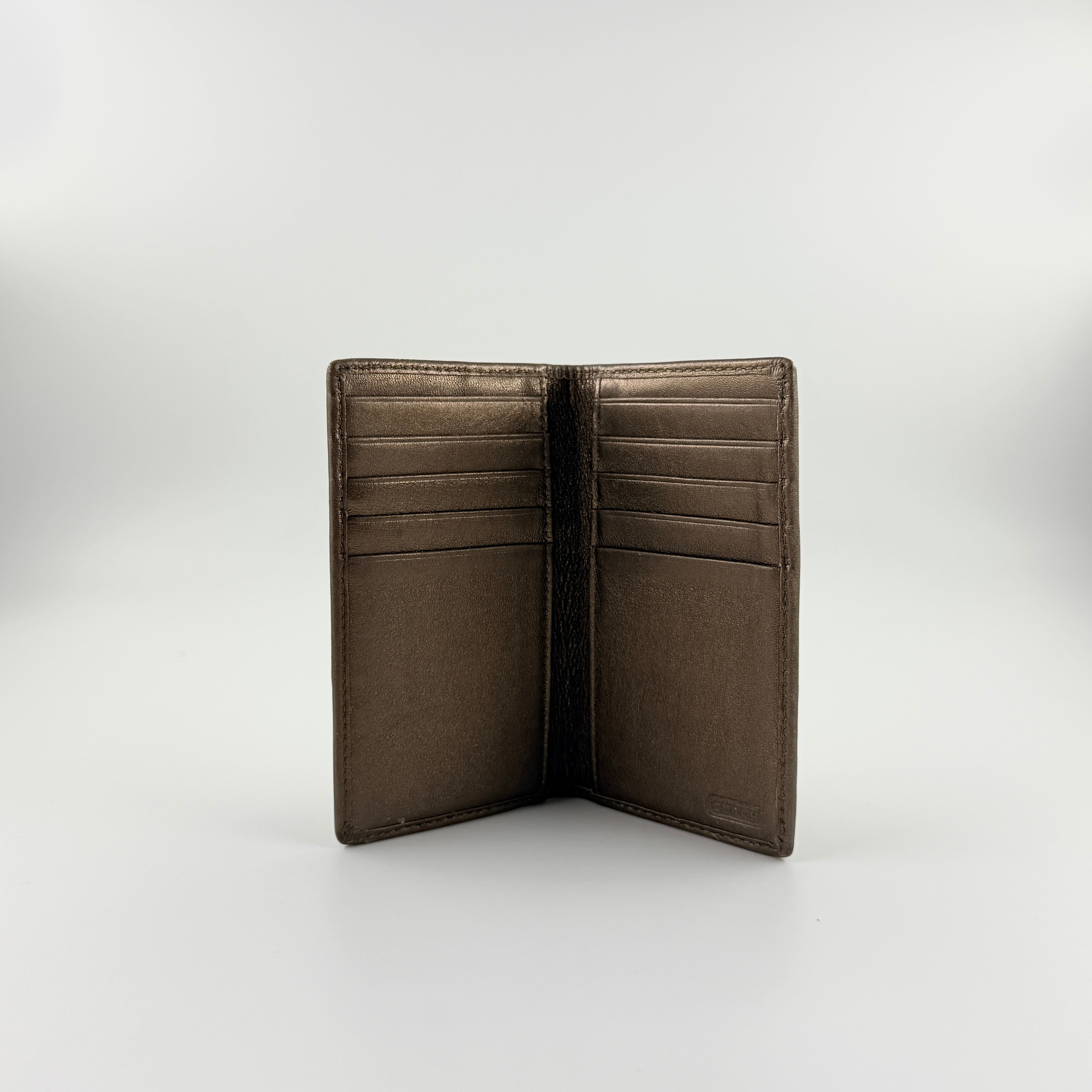 Coach Signature Stripe Snap Wallet in brown jacquard canvas with leather trim and embossed logo, shown against a white background.