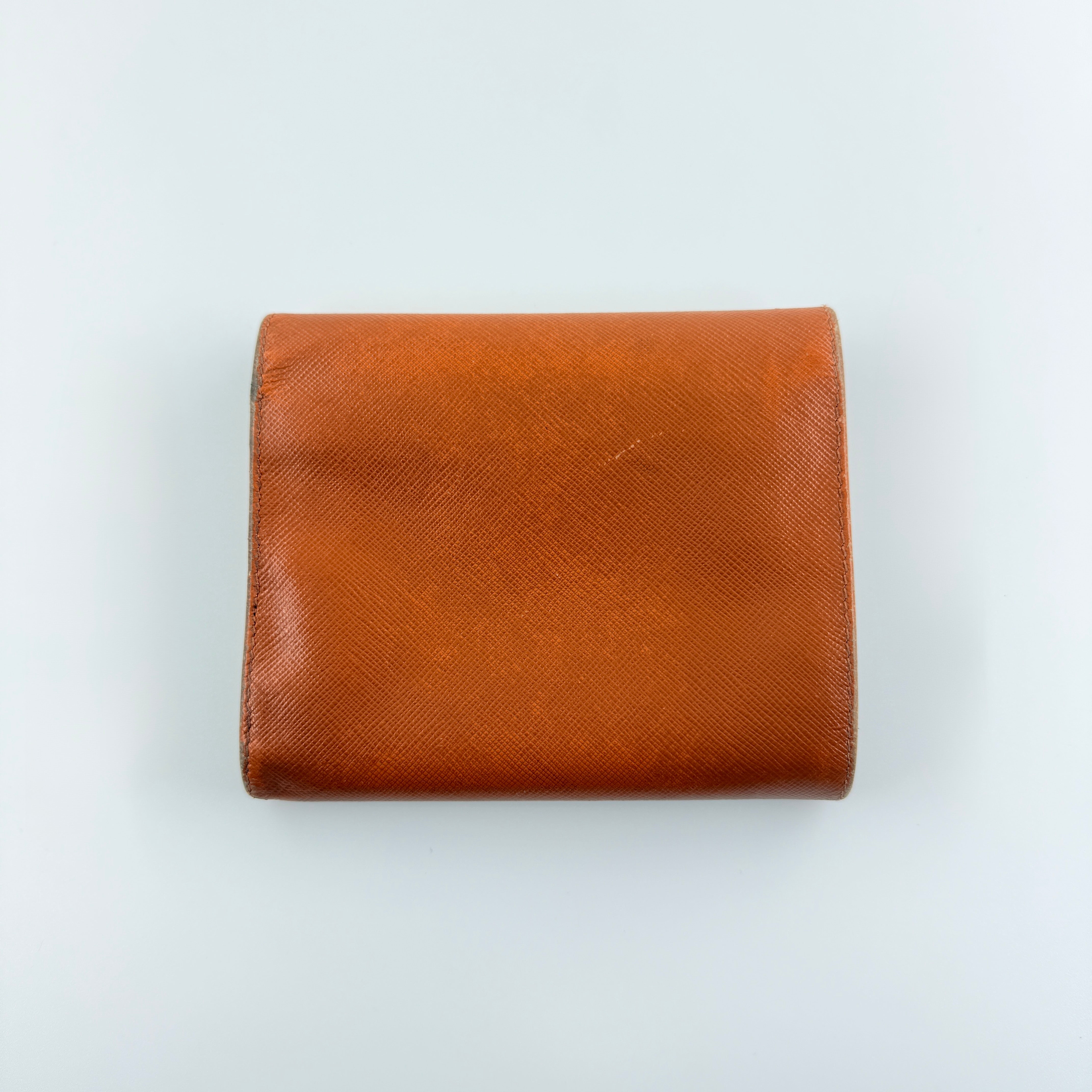 Prada Saffiano Leather Trifold Wallet in brown leather with gold-tone logo, showcasing its structured flap and crosshatch texture.