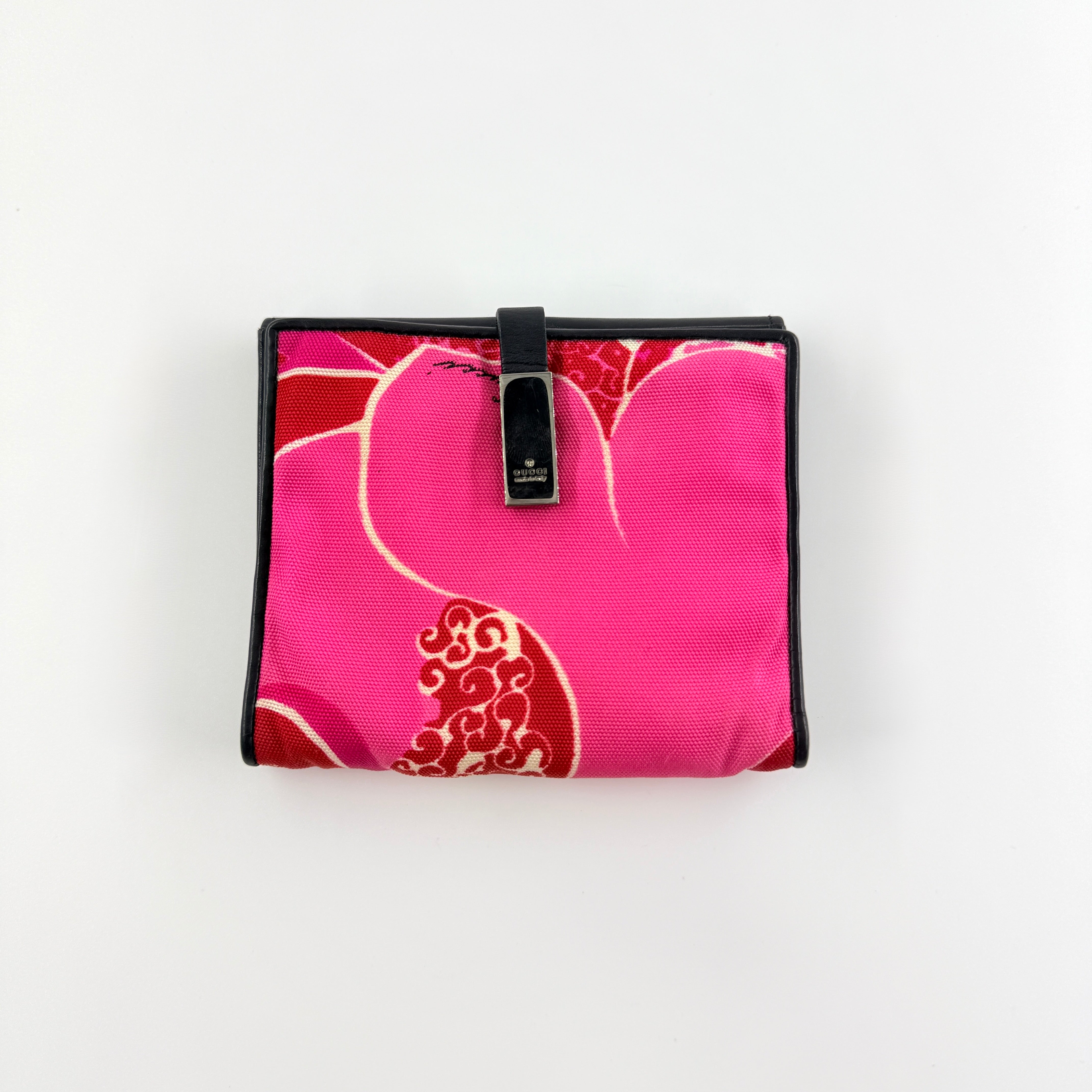 Gucci compact wallet with vibrant pink floral canvas, black leather trim and a silver-tone clasp, front view.