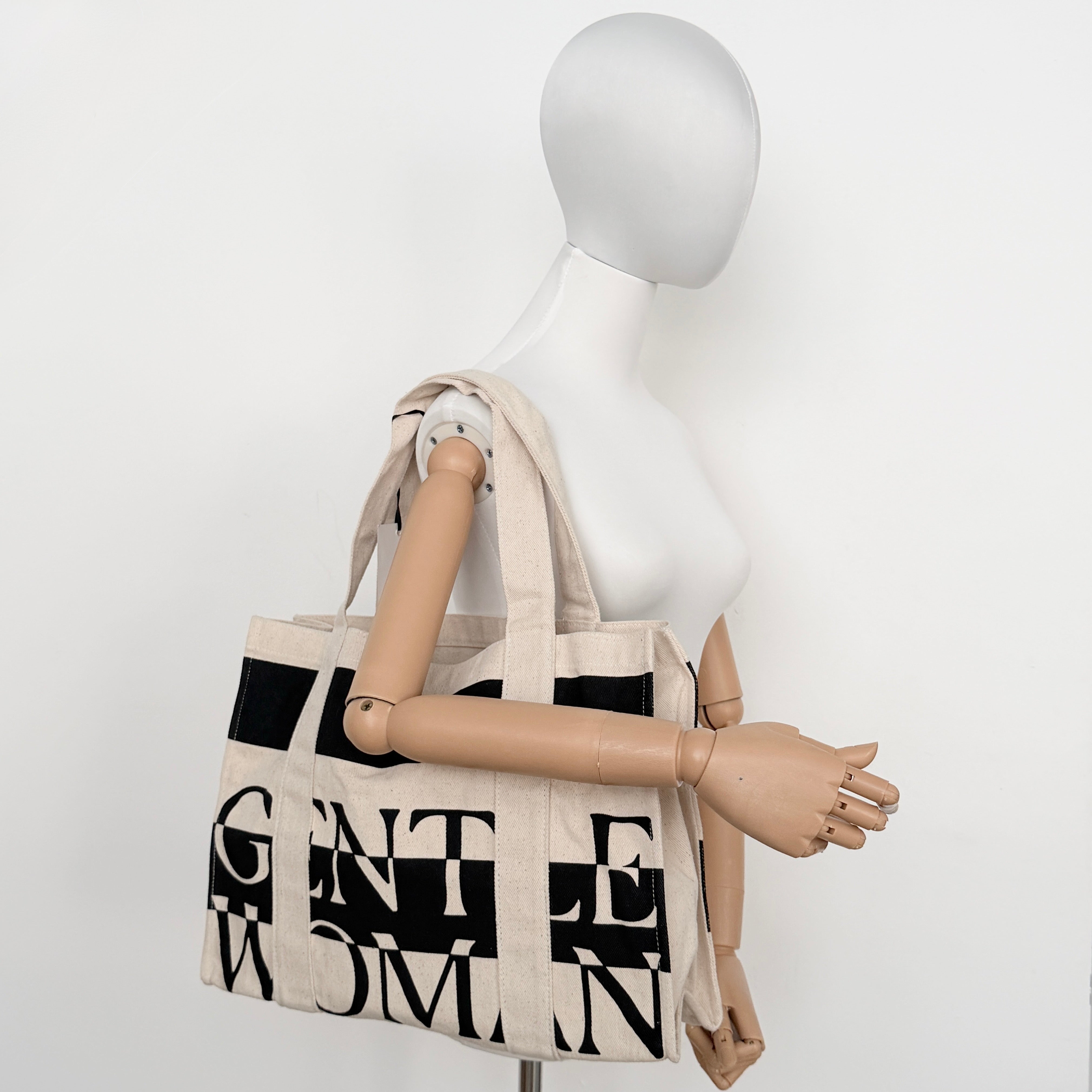 Gentlewoman Canvas Tote Bag in cream and black canvas with bold oversized logo and twin carry handles.