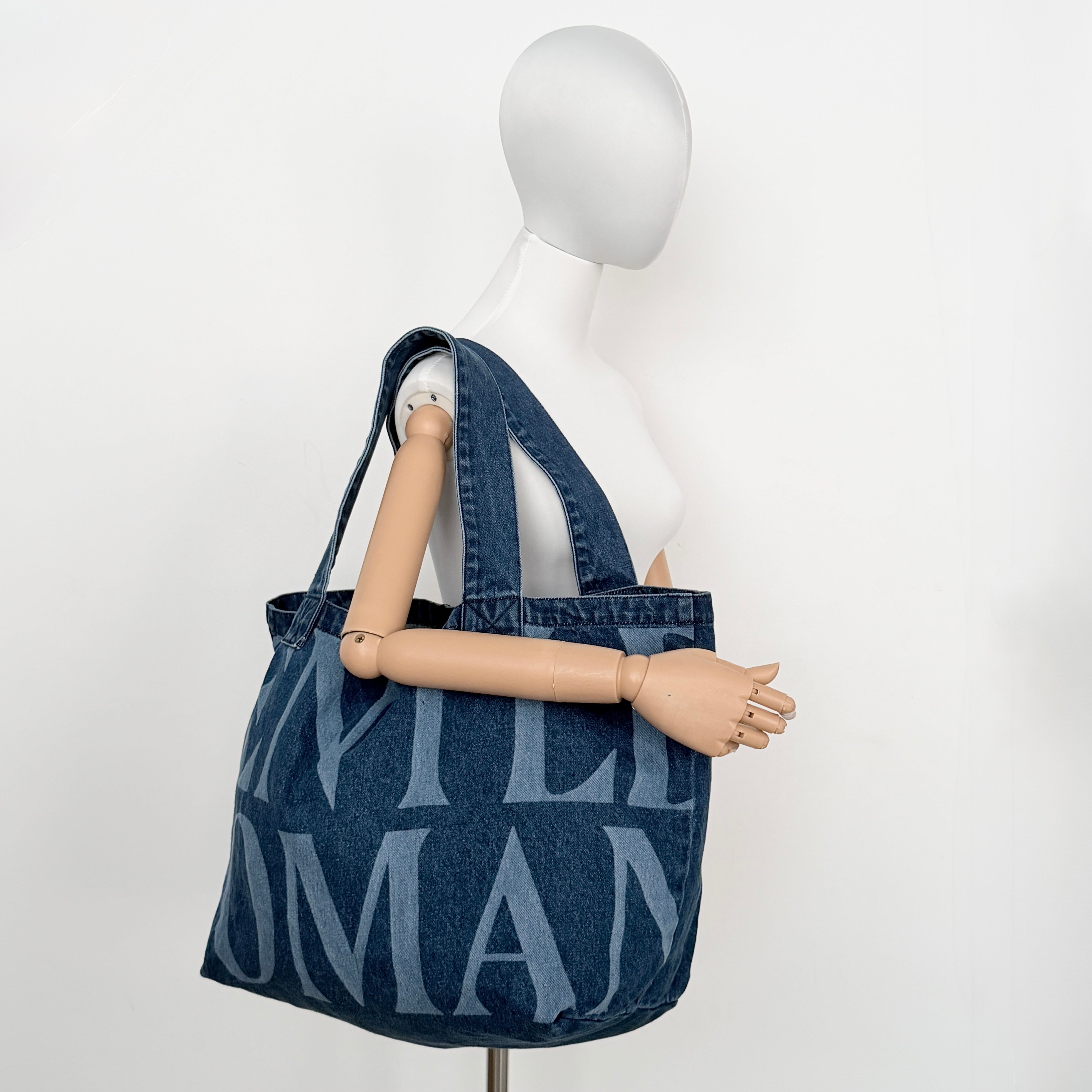 GENTLEWOMAN Jumbo Tote Bag in blue denim with oversized pale blue monogram, featuring sturdy twin handles.