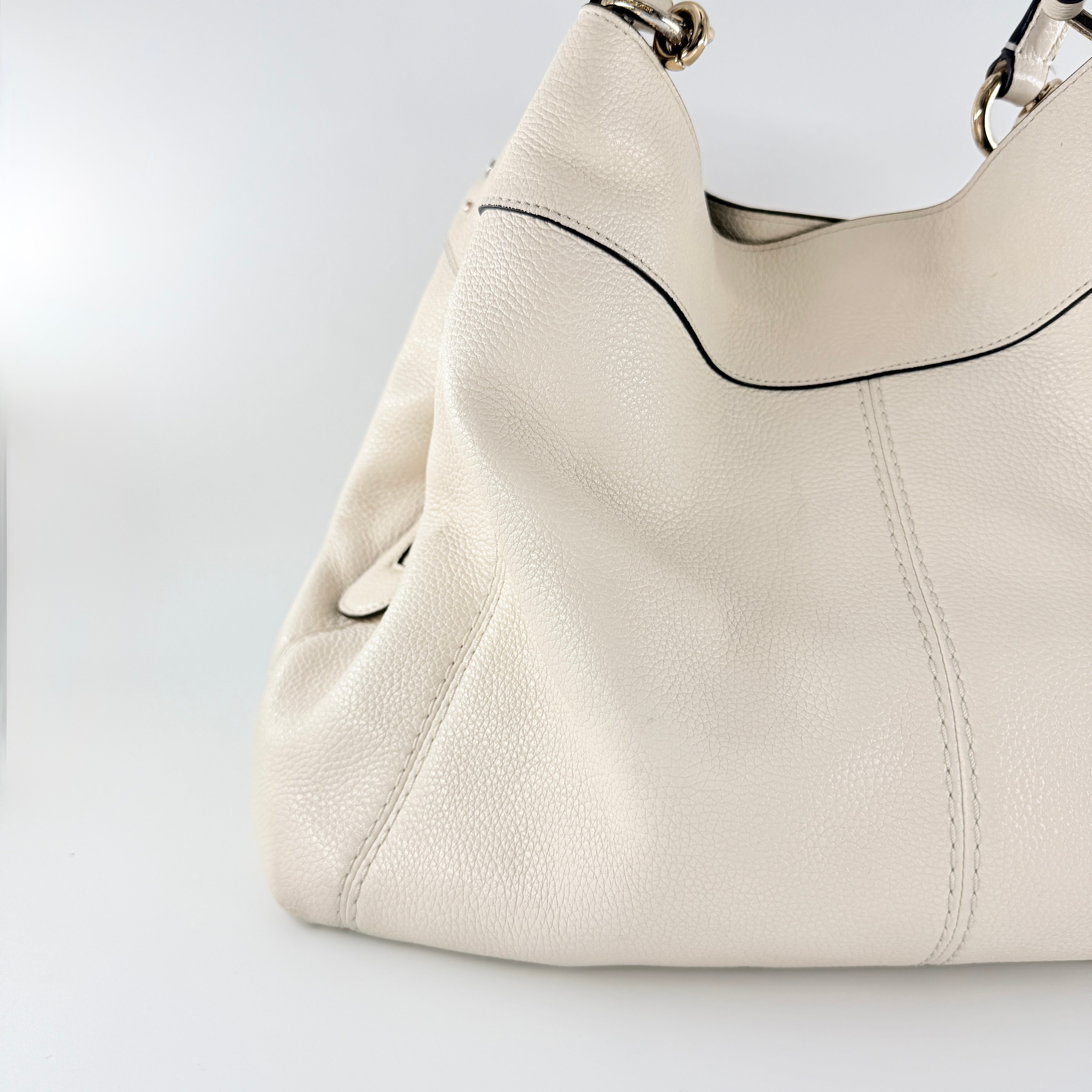 Coach Lexy Stardust Studded Chalk Hobo in ivory pebbled leather, adorned with mixed metal studs and dual handles.