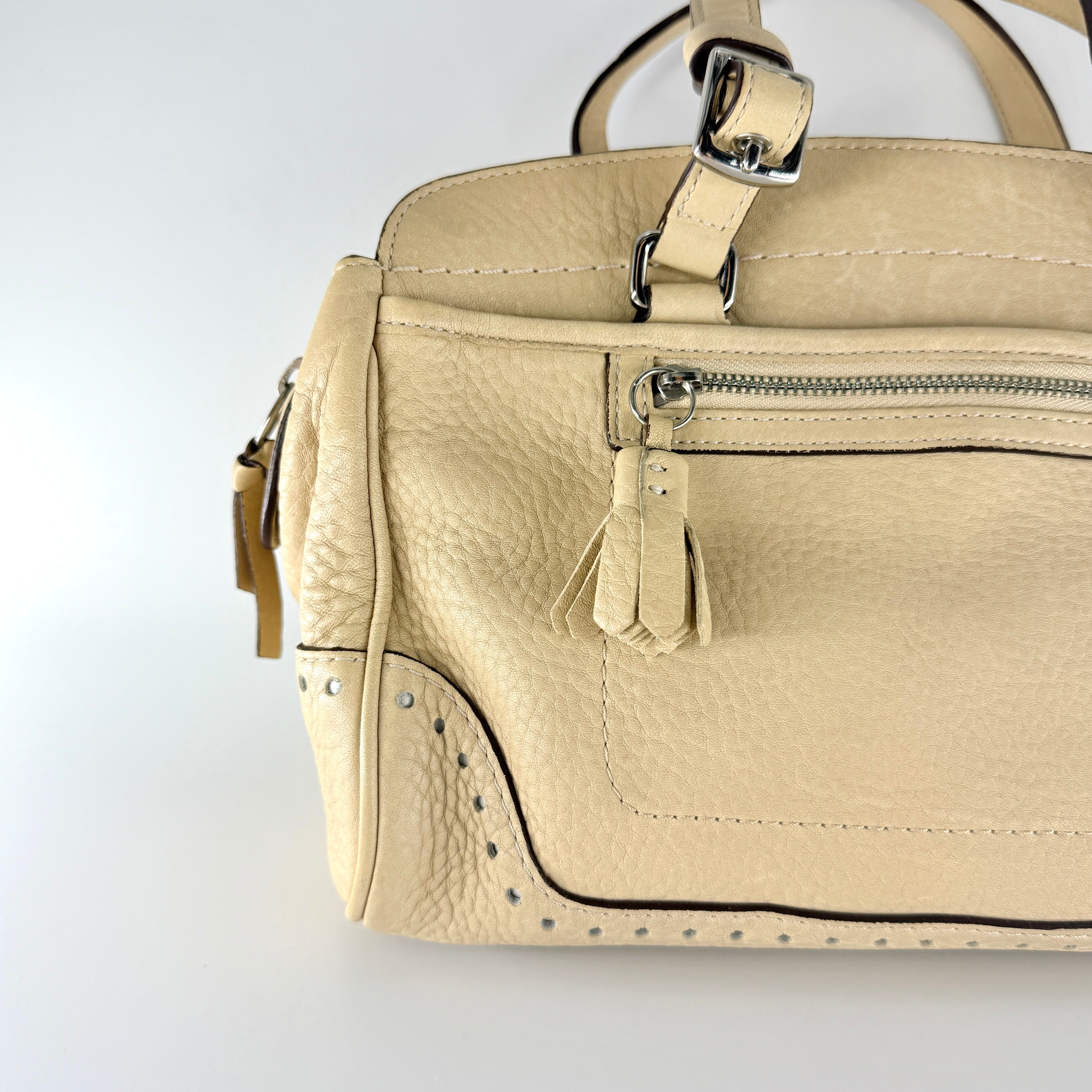 Coach Hampton Sand Satchel in beige pebbled leather with structured dual handles, front zip pocket, and silver-tone hardware.