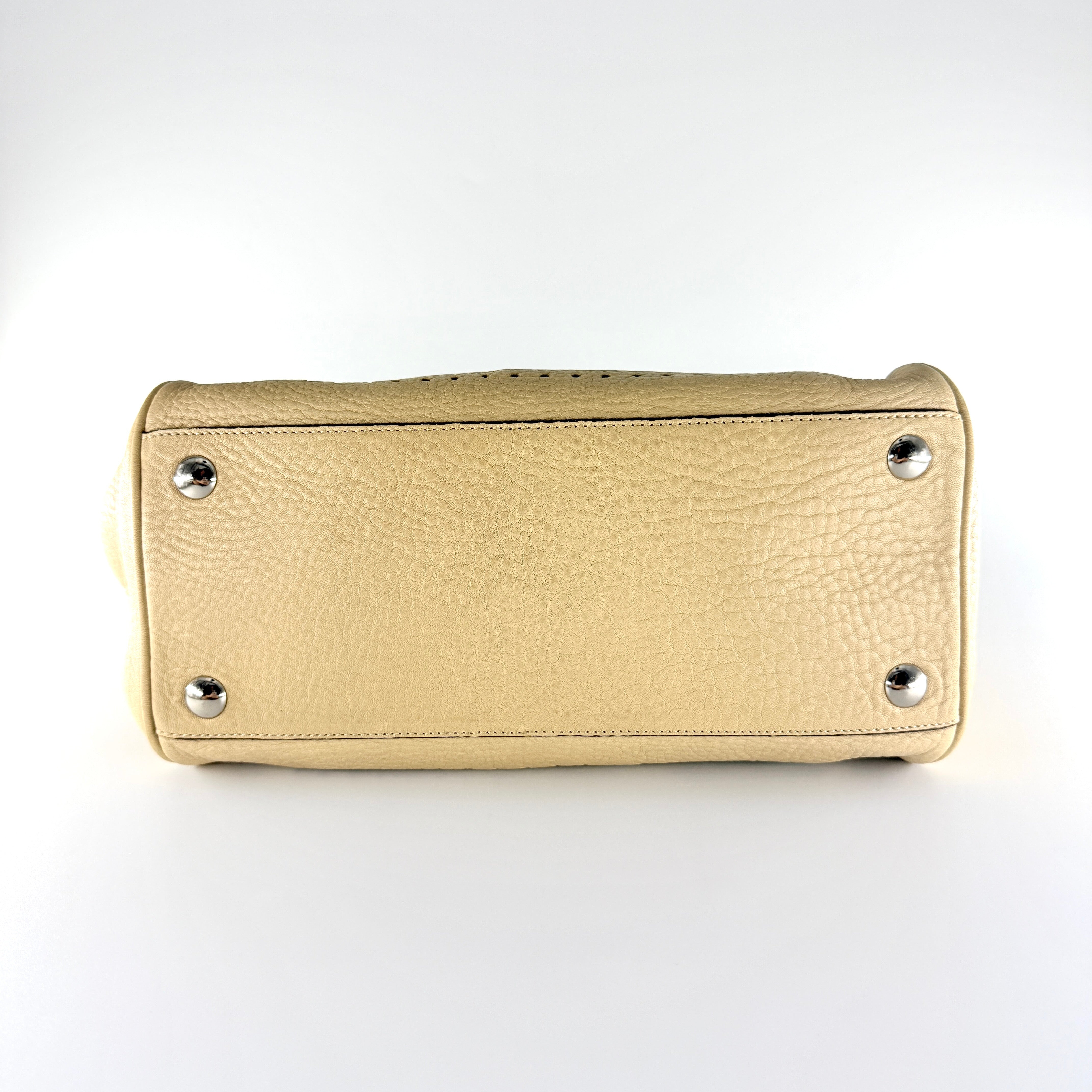 Coach Hampton Sand Satchel in beige pebbled leather with structured dual handles, front zip pocket, and silver-tone hardware.
