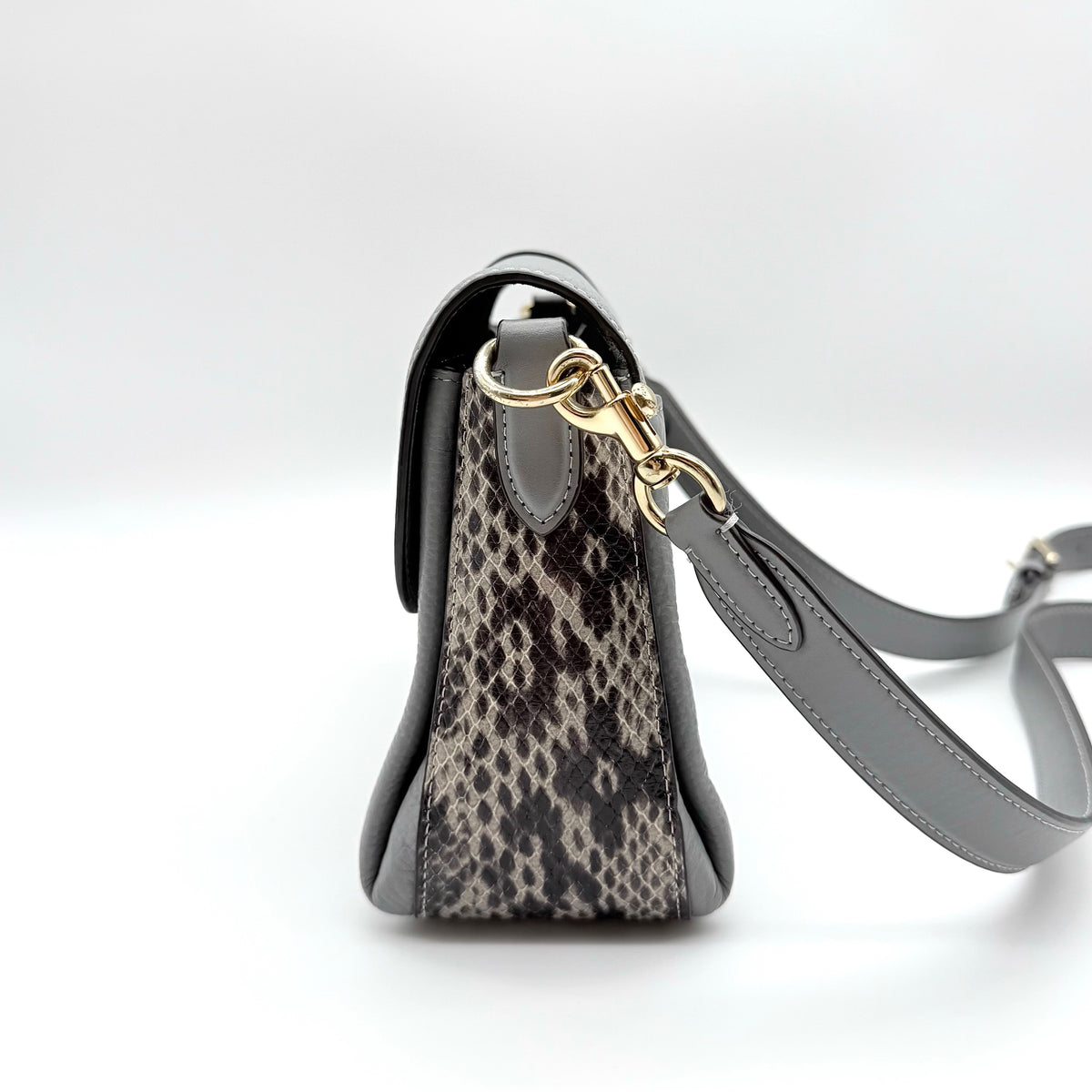 Coach Grace grey pebbled leather shoulder bag with python-embossed sides and gold coach carriage hardware, styled with a long adjustable strap.