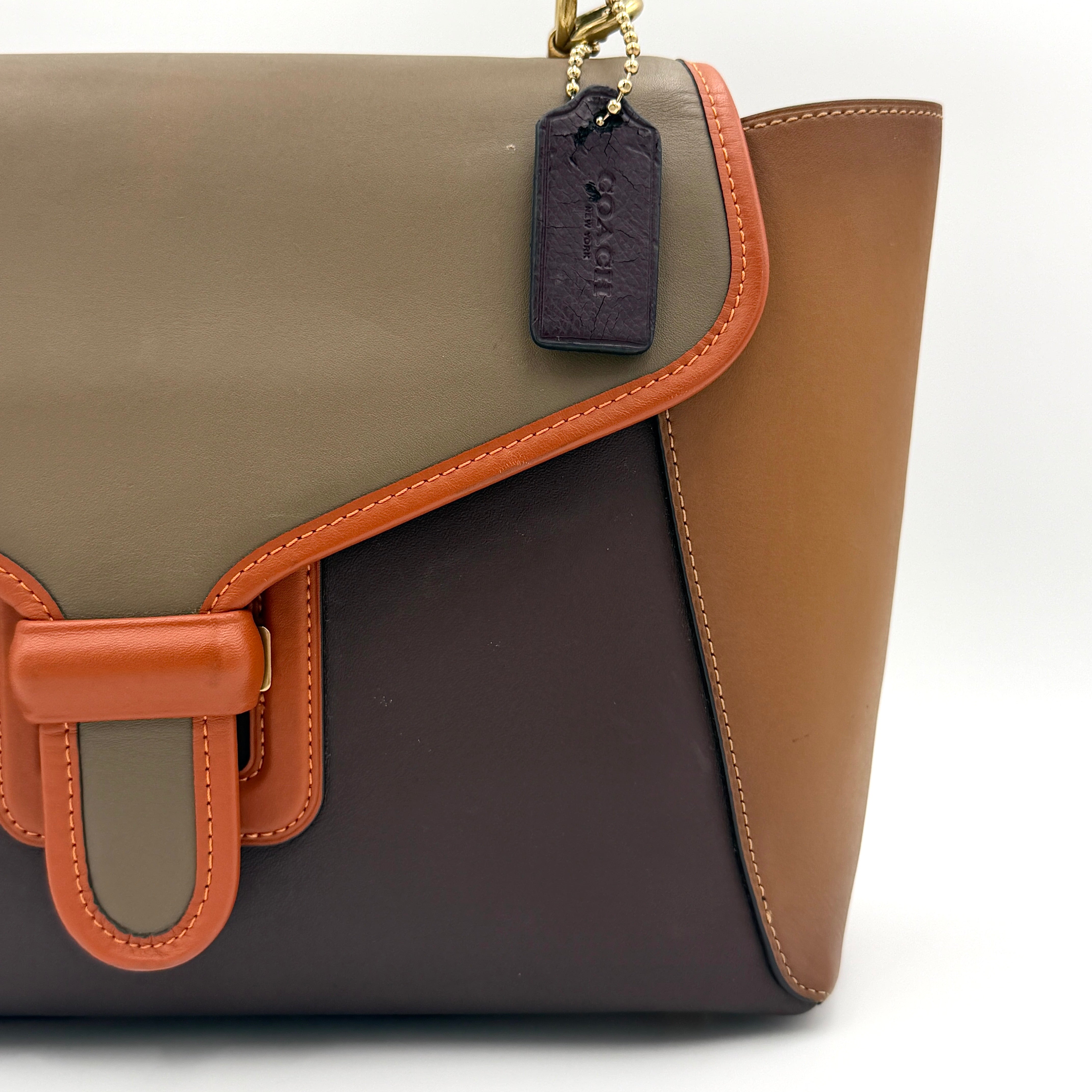 Coach 2Way Courier Carryall in brown and olive green colorblock leather with a structured silhouette, top handle, and detachable strap.