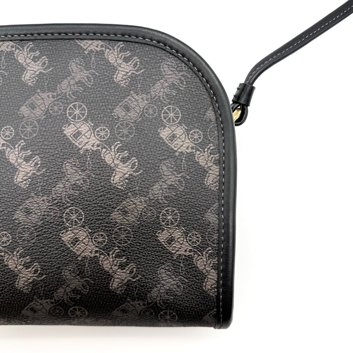 Coach Horse & Carriage Print Zip Crossbody Bag in black coated canvas with adjustable strap and gold hardware.
