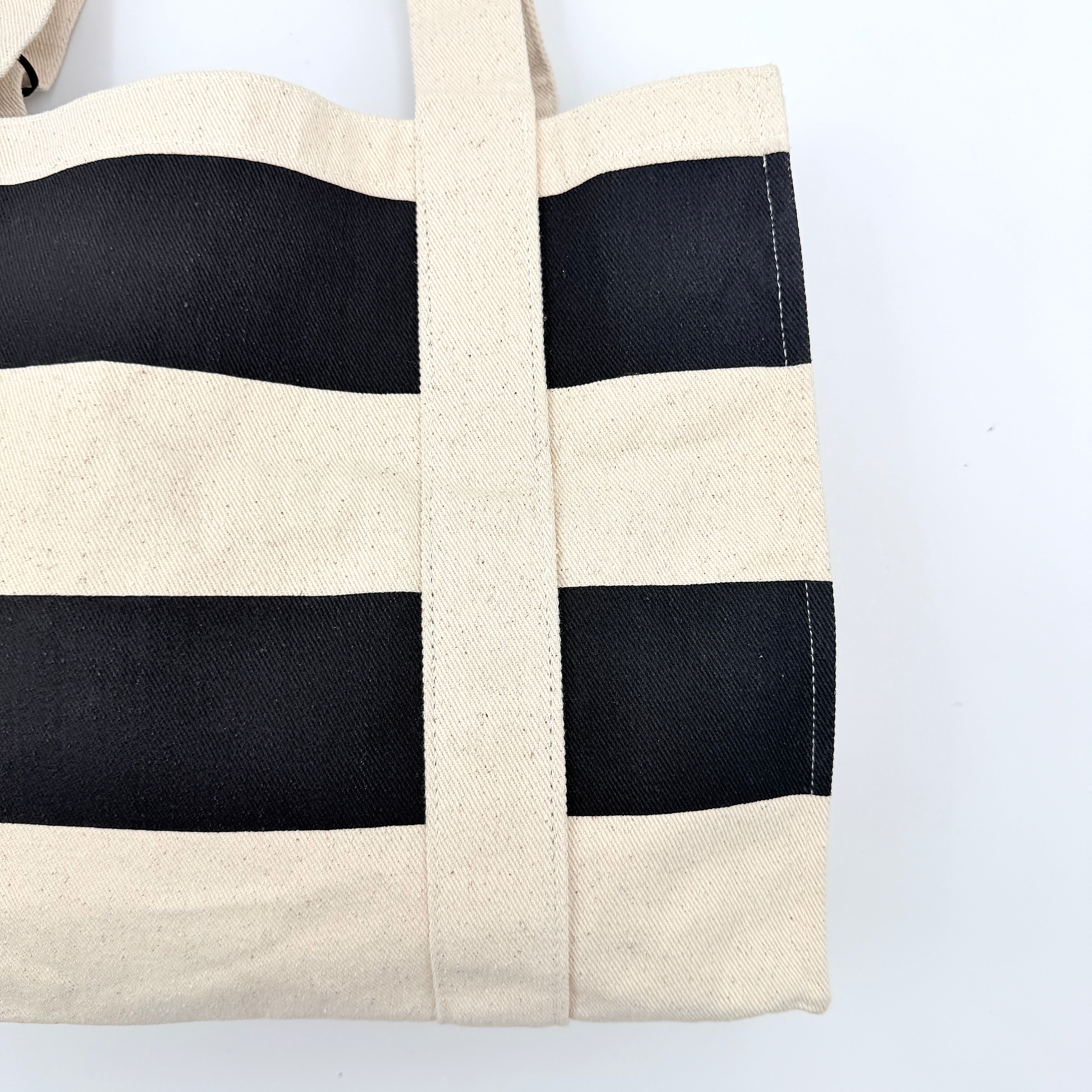 Gentlewoman Canvas Tote Bag in cream and black canvas with bold oversized logo and twin carry handles.