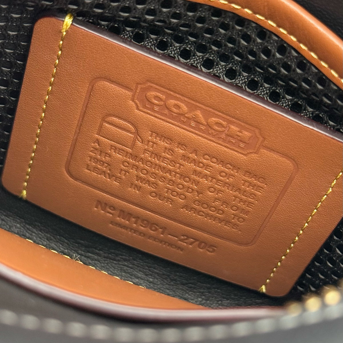 Coach Horse & Carriage Print Zip Crossbody Bag in black coated canvas with adjustable strap and gold hardware.