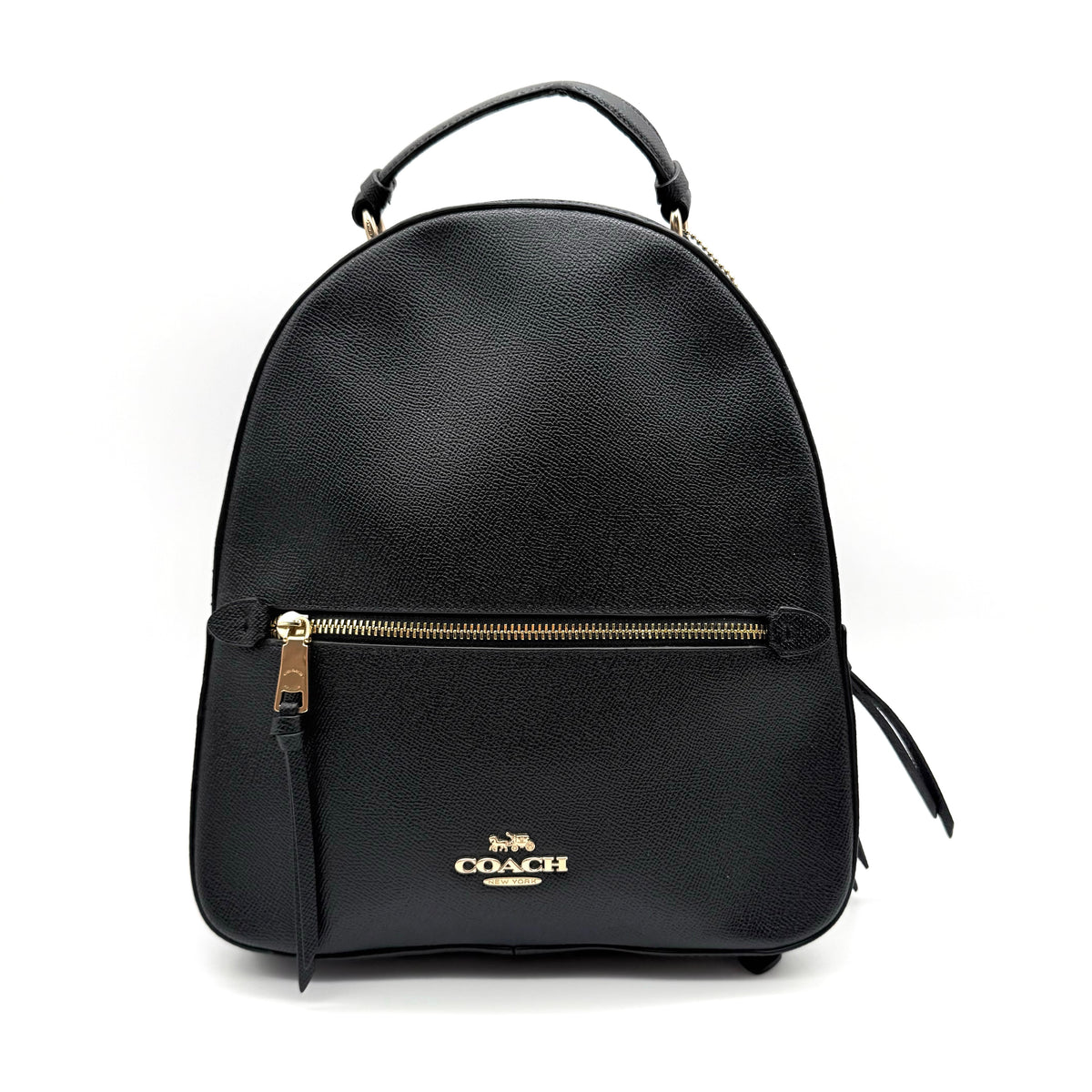 Coach Jordyn Leather Backpack in black grained leather with gold-tone hardware and minimal branding, photographed on white background.