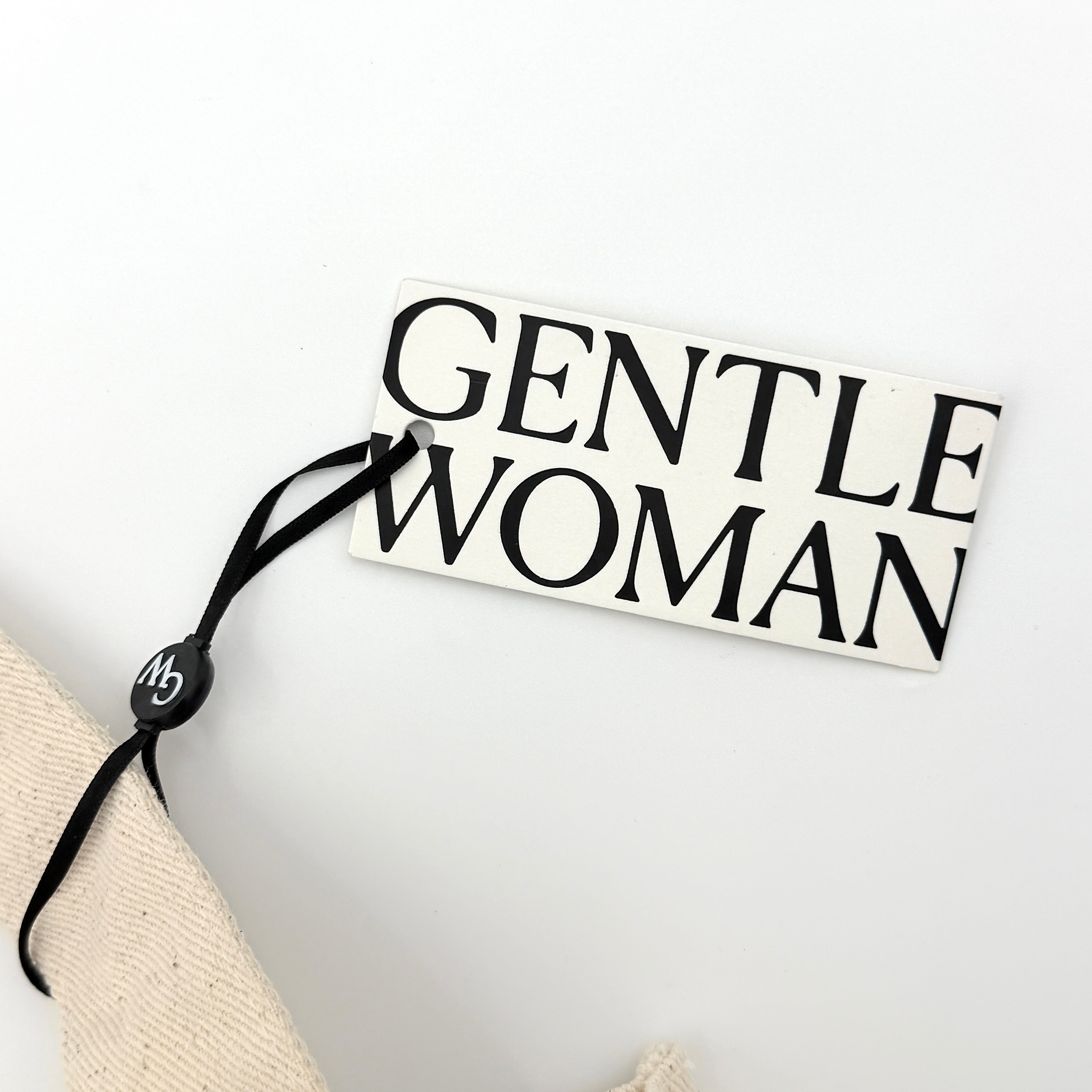 Gentlewoman Canvas Tote Bag in cream and black canvas with bold oversized logo and twin carry handles.