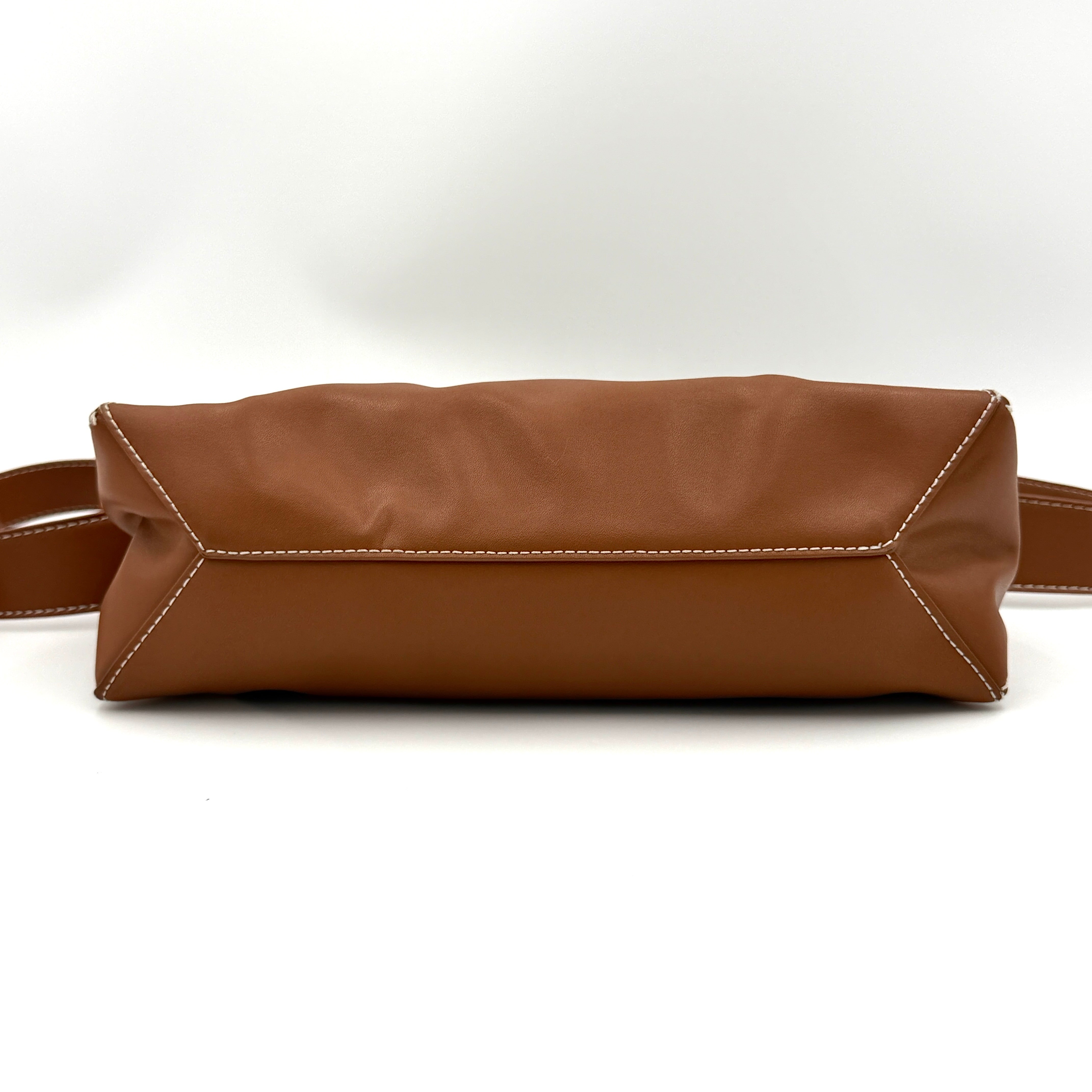Charles & Keith Nasrin Geometric Crossbody Bag in brown faux leather with angular stitching, gold-tone hardware, and adjustable strap.