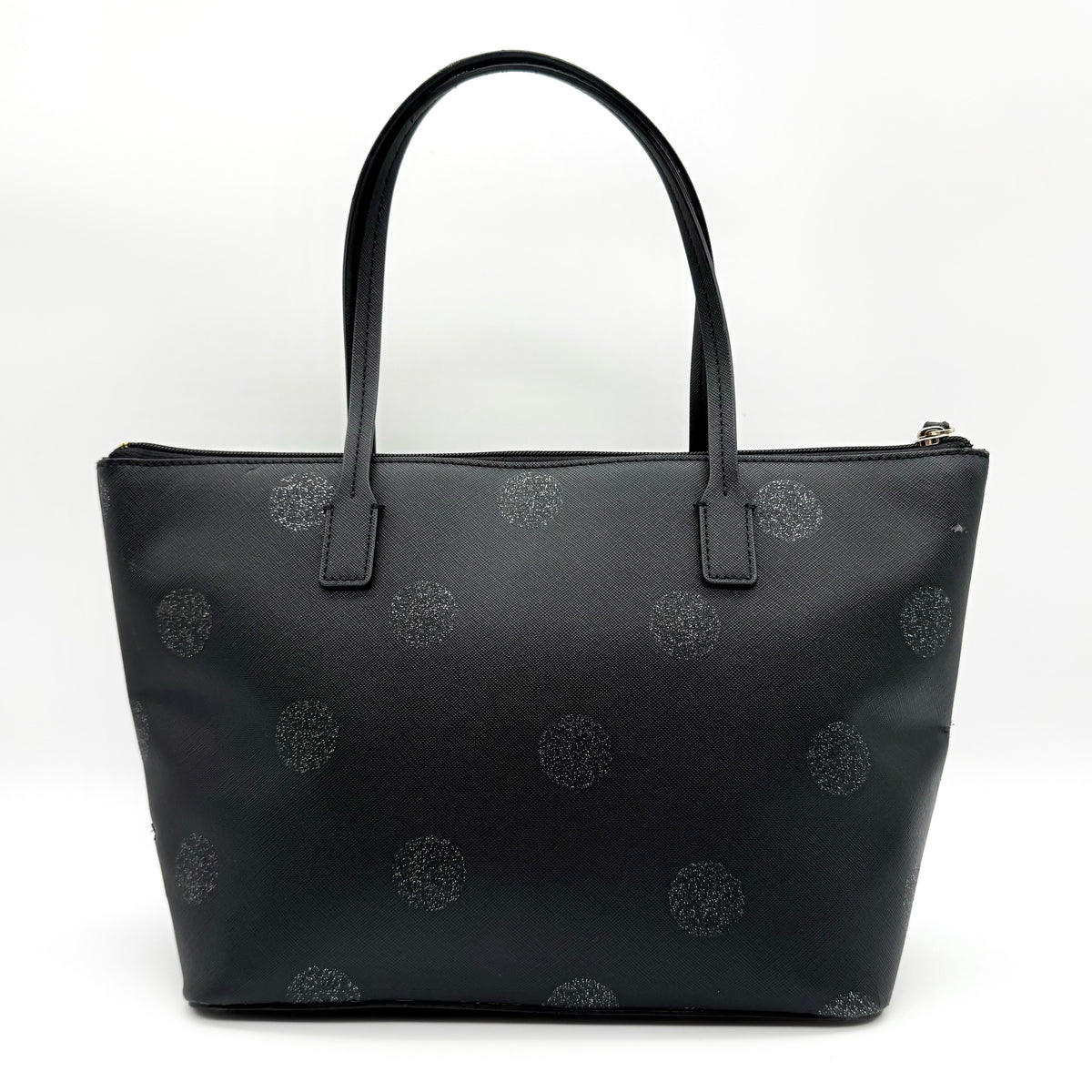 Front view of a Kate Spade black tote bag with glitter polka dots and dual handles.