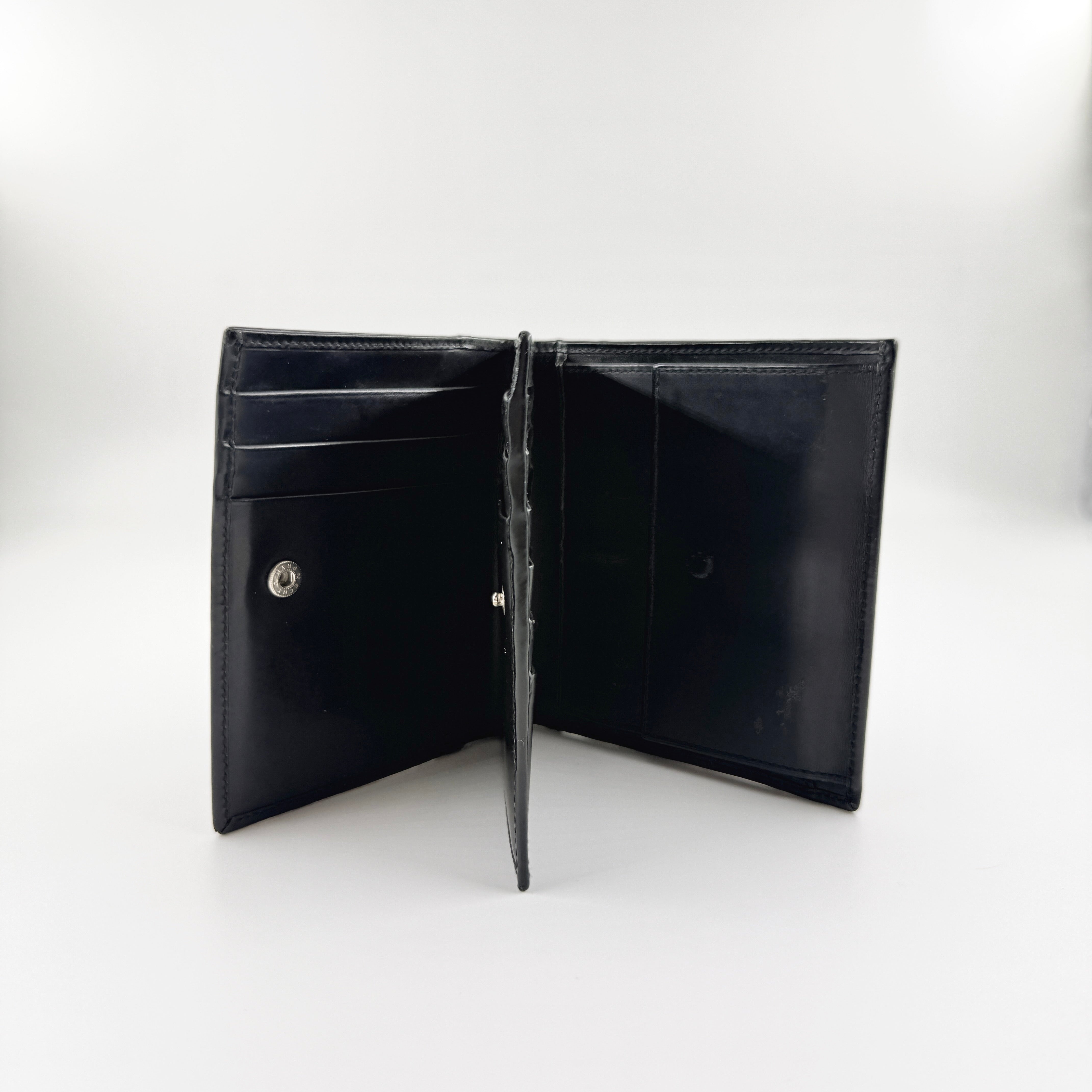 Gucci G Logo Bifold Wallet in black leather featuring a bold geometric G plaque and meticulously stitched edges.