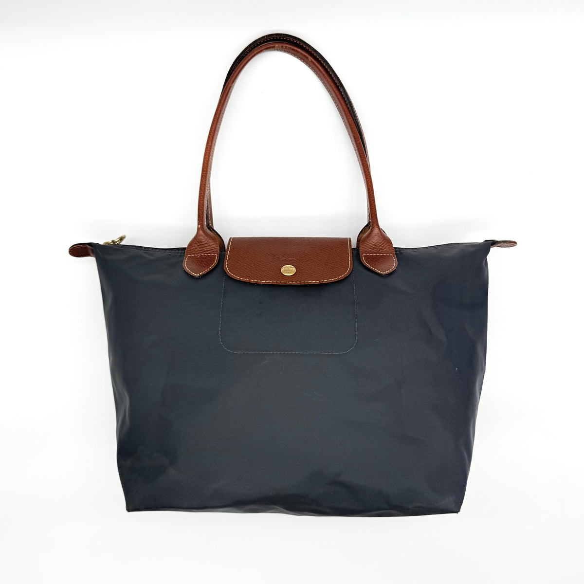 Longchamp Le Pliage Original Tote Bag in grey nylon with brown leather handles and flap, displayed against a white background.