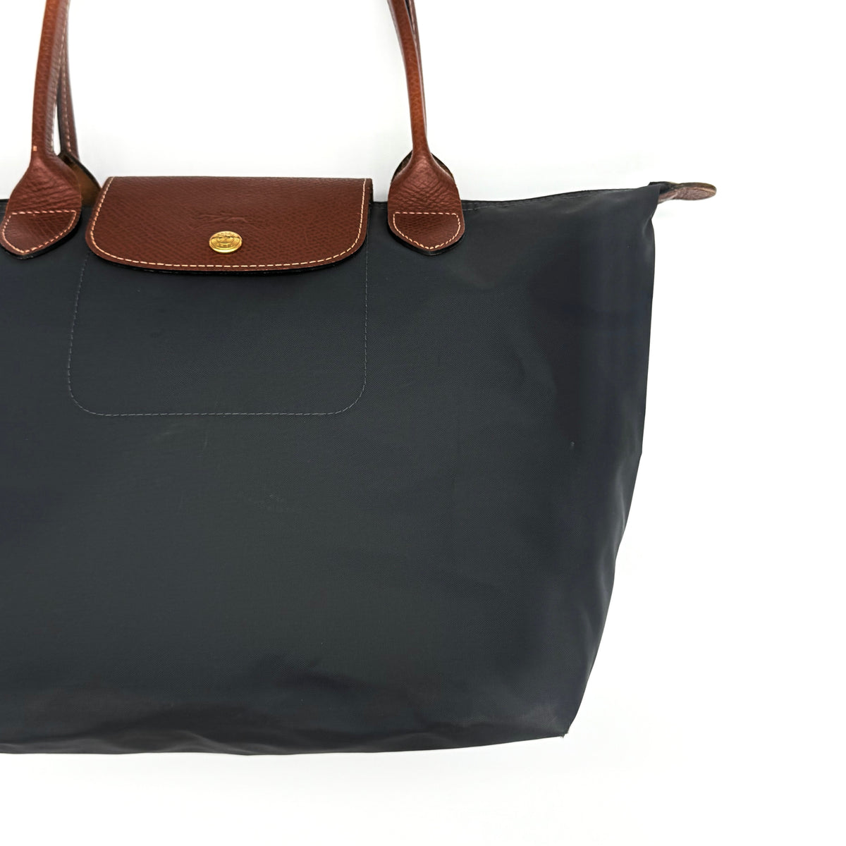 Longchamp Le Pliage Original Tote Bag in grey nylon with brown leather handles and flap, displayed against a white background.